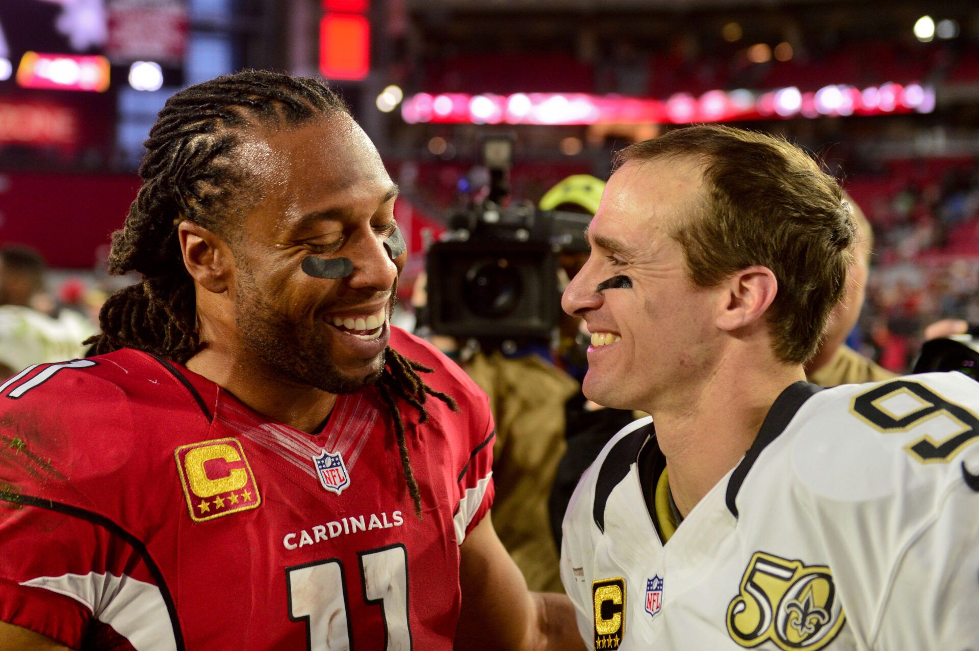 Arizona Cardinals wide receiver Larry Fitzgerald (11) and New Orleans Saints quarterback Drew Brees (9) talk after their game at University of Phoenix Stadium.