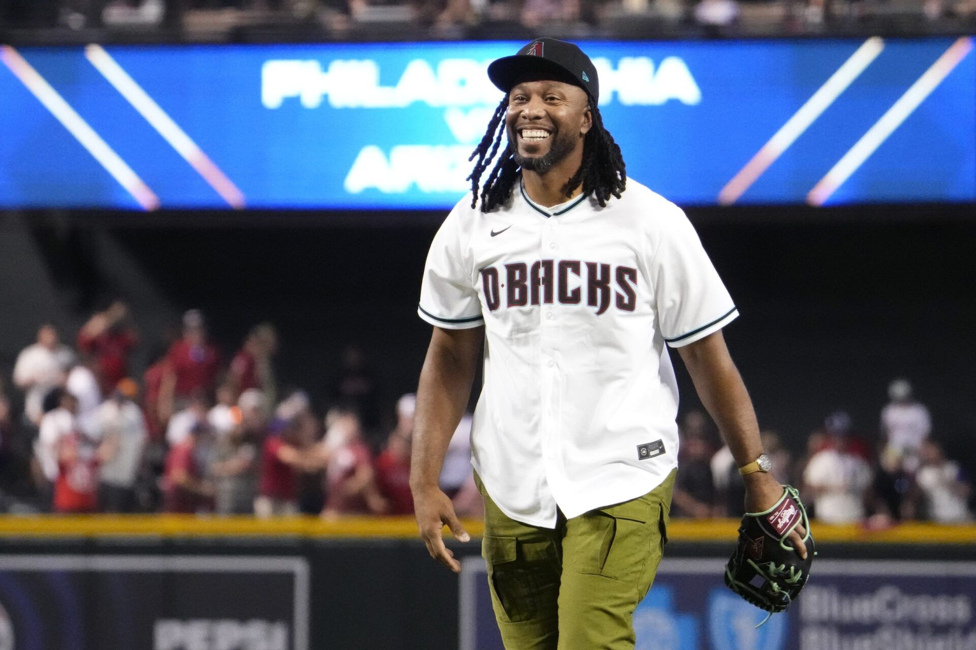 Arizona Cardinals receiver Larry Fitzgerald Jr. reacts after throwing out the ceremonial first pitch before game four of the NLCS of the 2023 MLB playoffs between the Diamondbacks and the Philadelphia Phillies at Chase Field in Phoenix on Oct. 20, 2023.