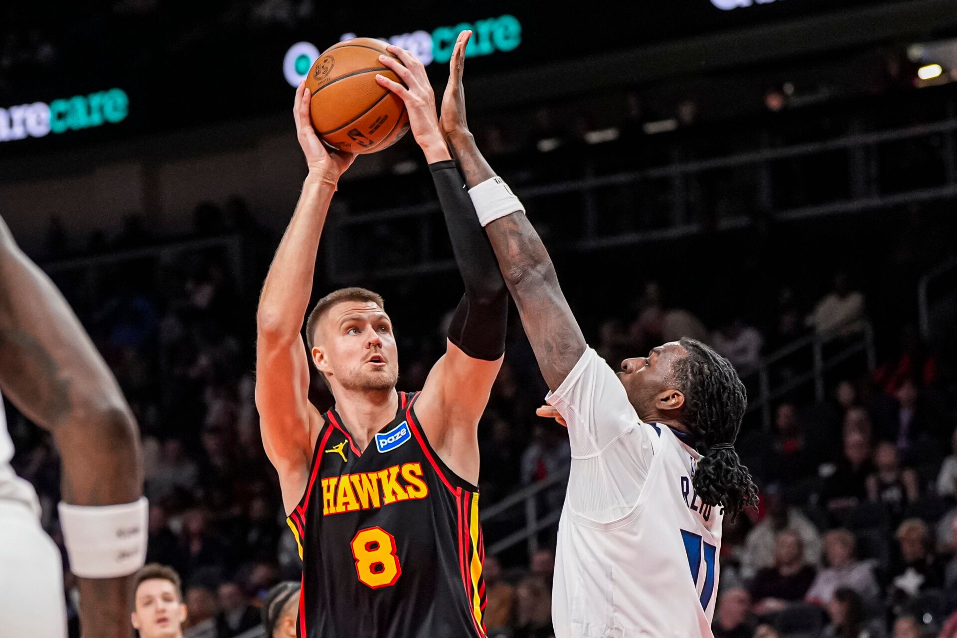 Atlanta Hawks center Kristaps Porzingis (8) shoots over Minnesota Timberwolves center Naz Reid (11) during the first half at State Farm Arena.