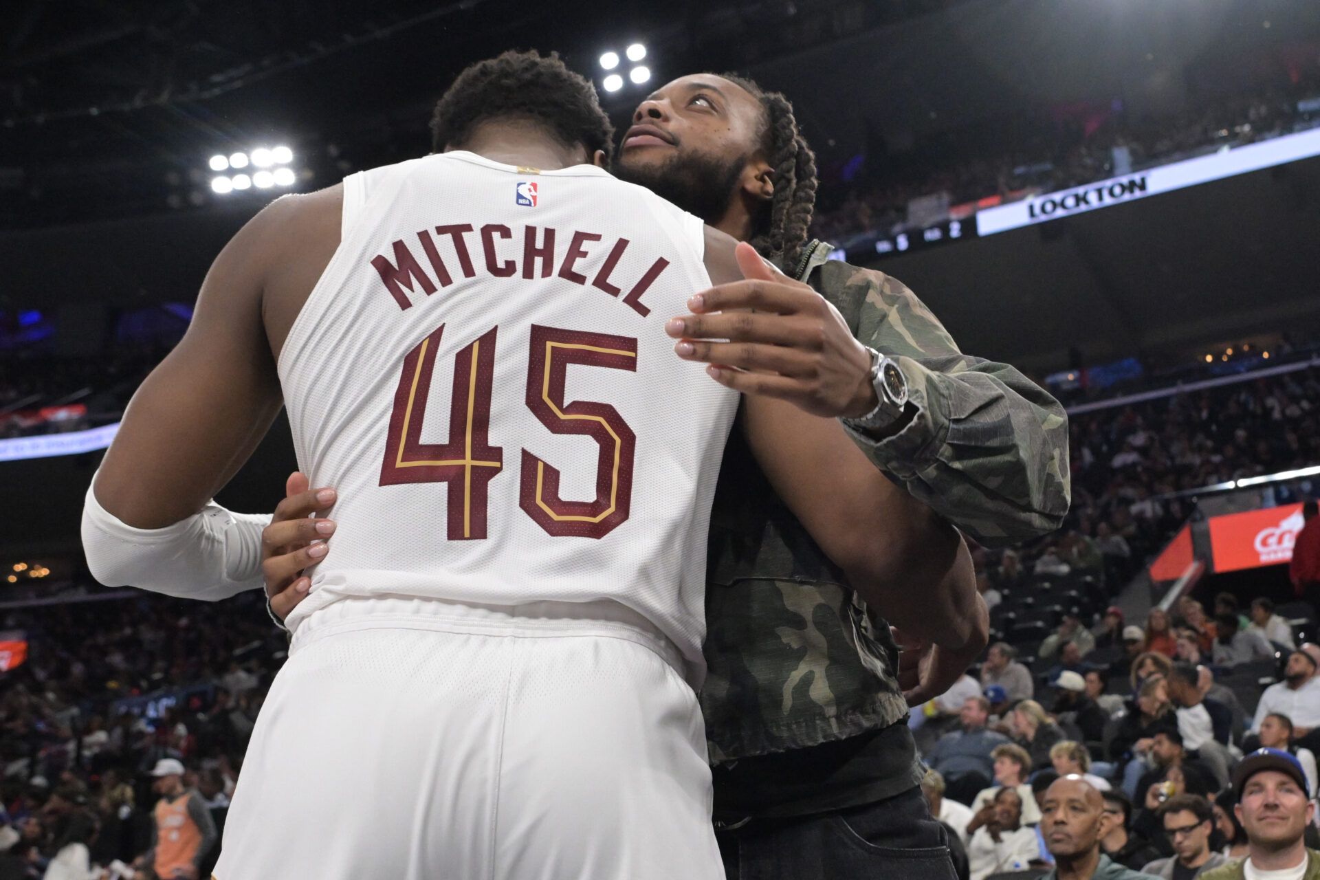 Los Angeles Clippers Darius Garland gets a hug from Cleveland Cavaliers guard Donovan Mitchell (45) during the second half at Intuit Dome.