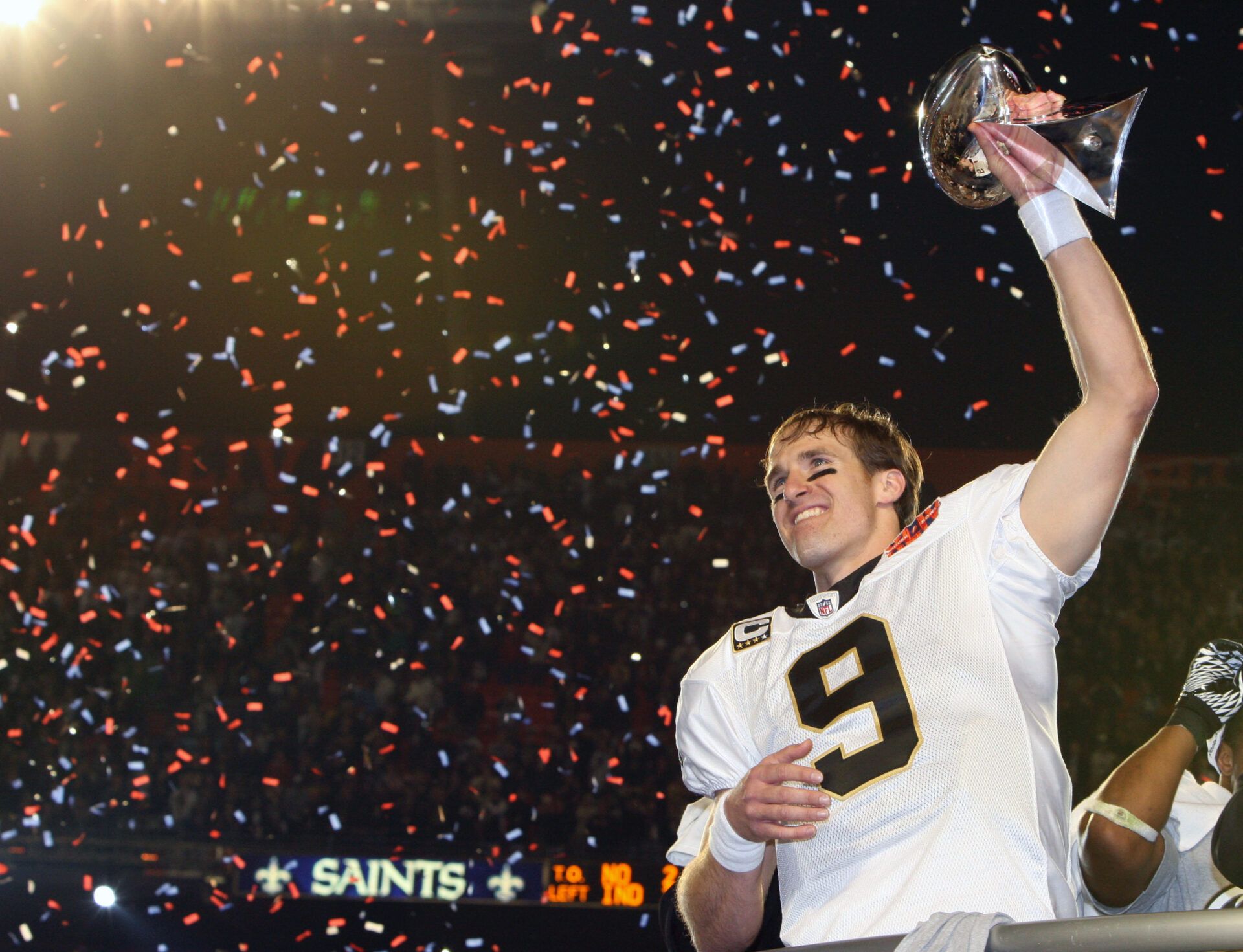 New Orleans Saints quarterback Drew Brees (9) hoists the Lombardi Trophy after defeating the Indianapolis Colts 31-17 in Super Bowl XLIV at Sun Life Stadium.