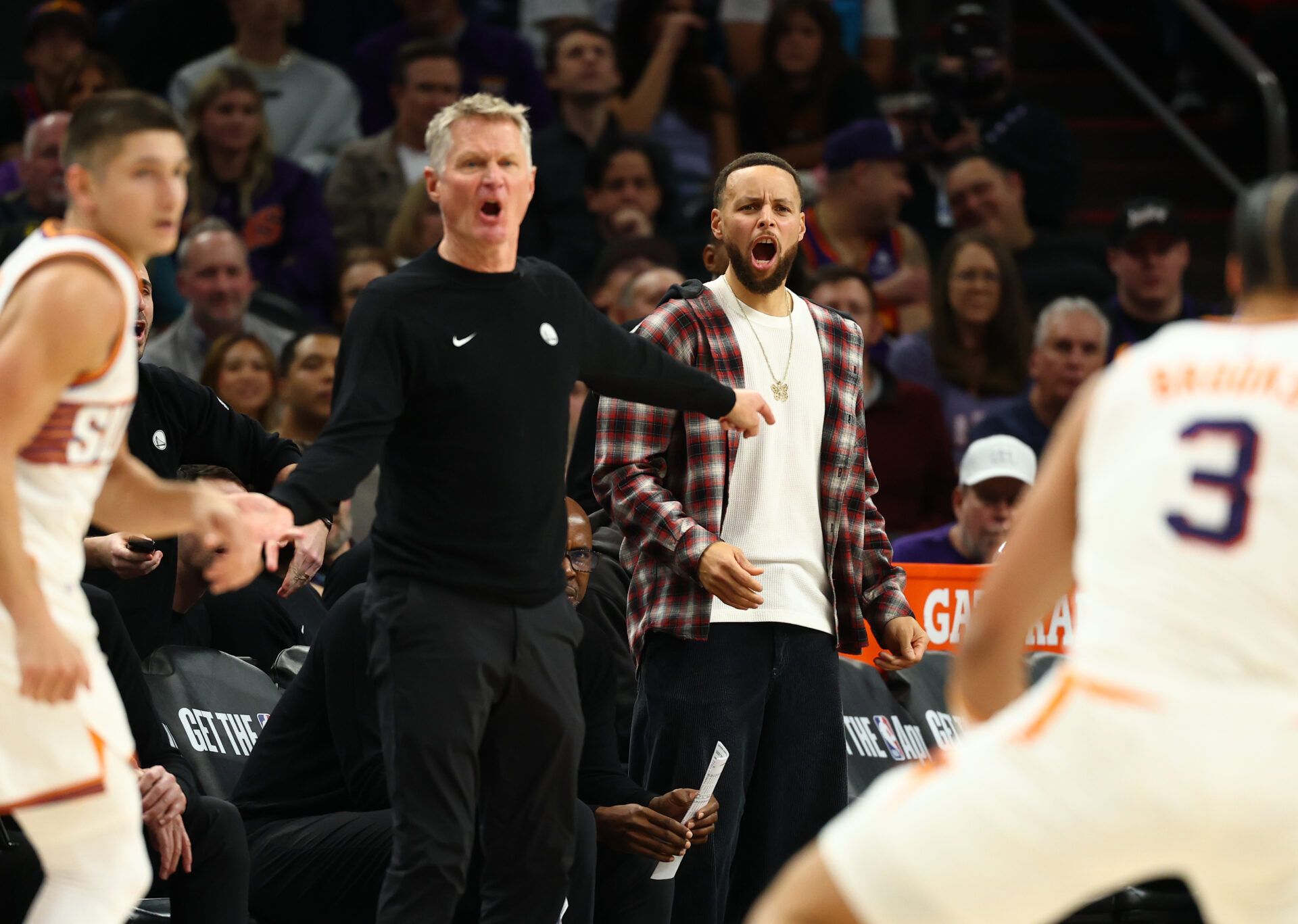 Golden State Warriors guard Stephen Curry (right) and head coach Steve Kerr react against the Phoenix Suns in the first half at Mortgage Matchup Center.