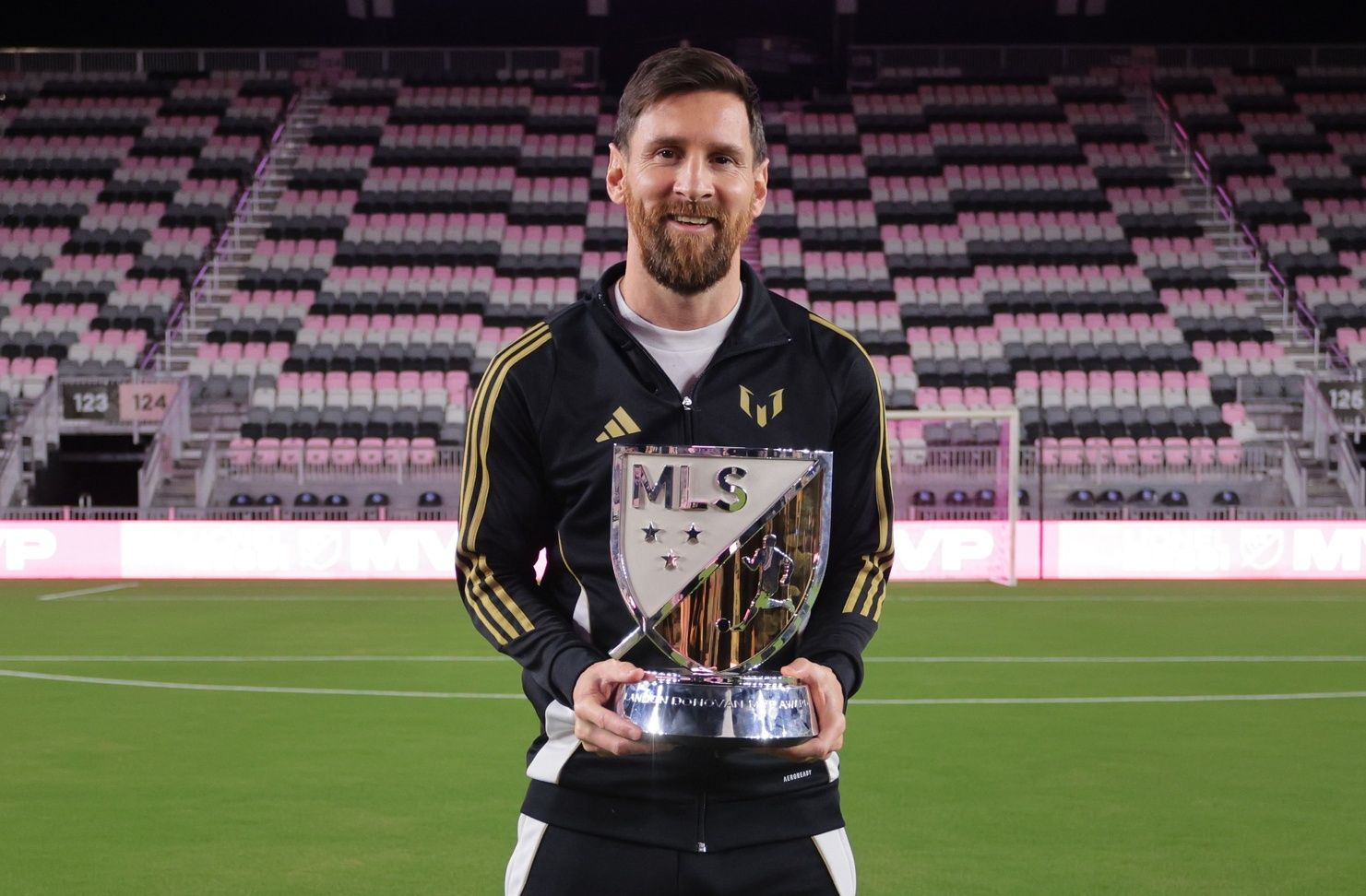 Inter Miami CF forward Lionel Messi (10) holds the London Donovan MVP Award during a presentation ceremony at Chase Stadium.