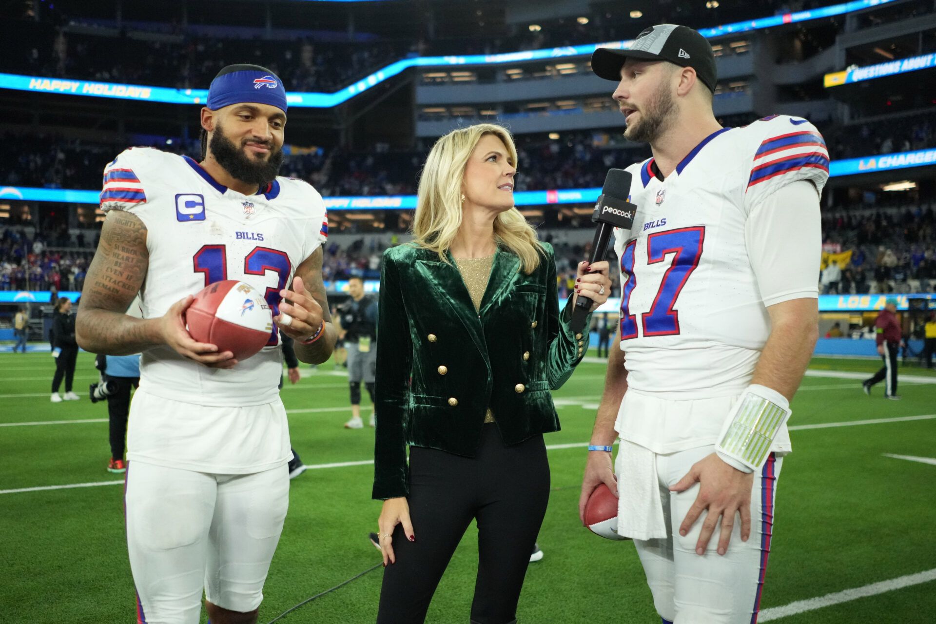 NBC Sports sideline reporter Melissa Stark (center) interviews Buffalo Bills wide receiver Gabe Davis (13) and quarterback Josh Allen (17) after the game against the Los Angeles Chargers at SoFi Stadium.