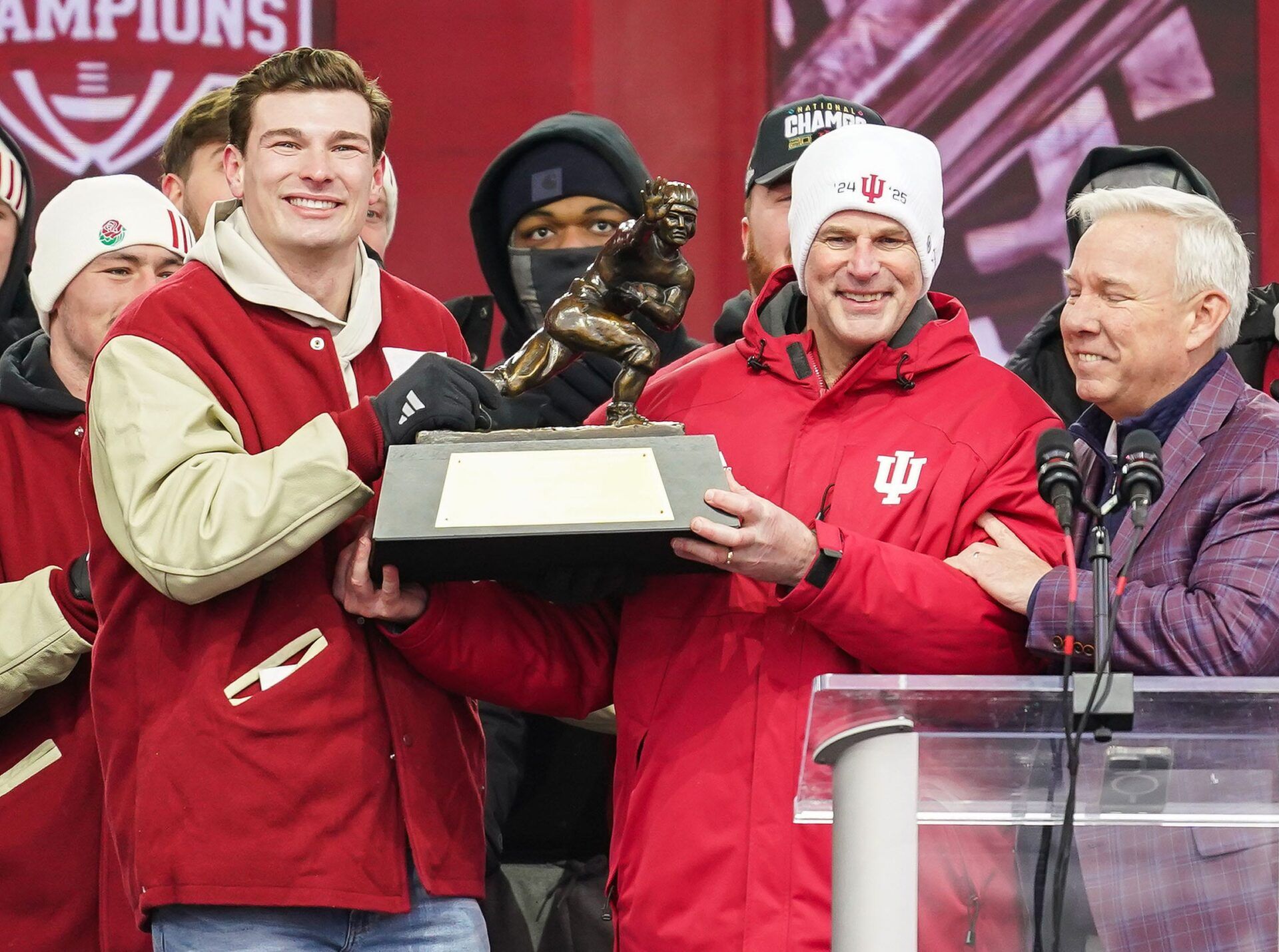 Indiana Hoosiers quarterback Fernando Mendoza (15) holds the Heisman Trophy with Indiana Hoosiers head coach Curt Cignetti on Saturday, Jan. 24, 2026, during the Indiana Football College Football Playoff National Championship celebration and parade at Memorial Stadium in Bloomington.