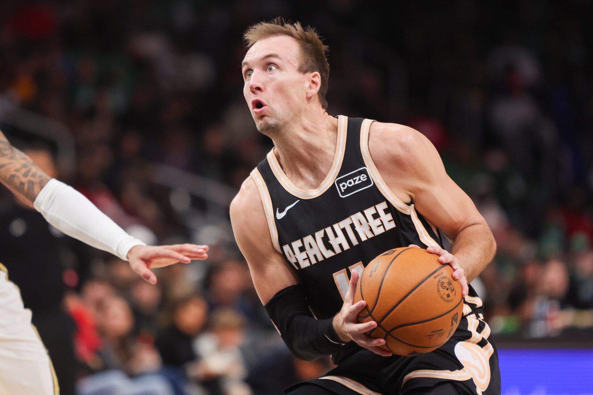 Atlanta Hawks guard Luke Kennard (4) shoots against the Boston Celtics in the first quarter at State Farm Arena.