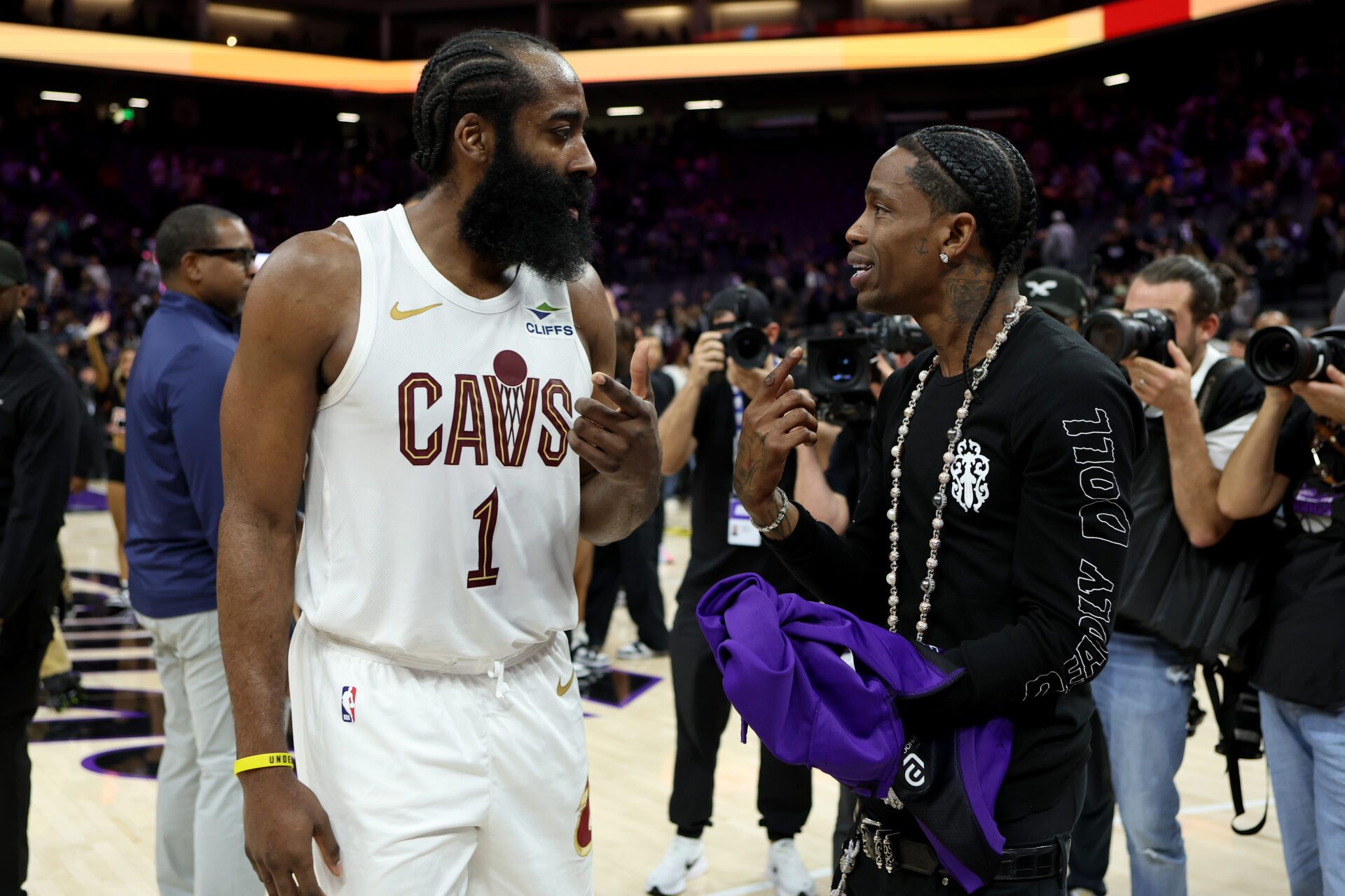 Cleveland Cavaliers guard James Harden (1) talks with rapper Travis Scott after a game against the Sacramento Kings at Golden 1 Center.