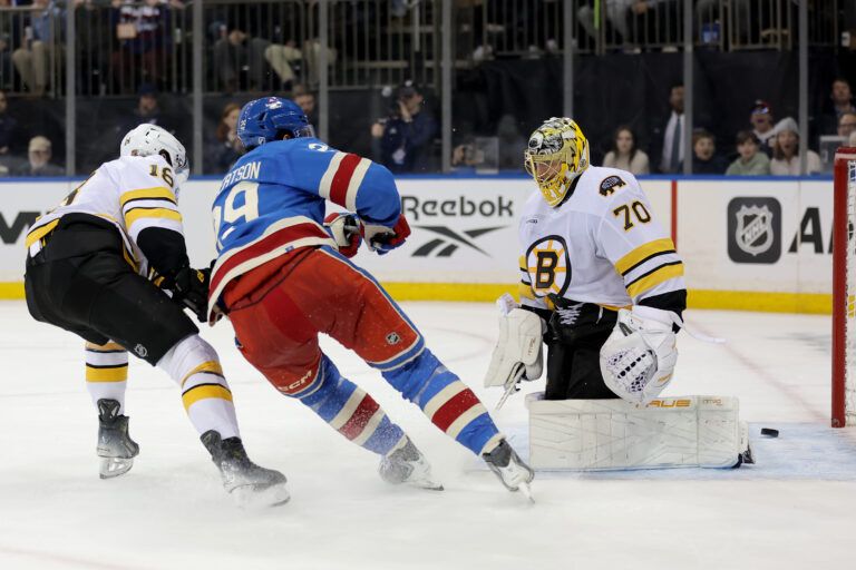 New York Rangers defenseman Matthew Robertson (29) scores an overtime game winning goal against Boston Bruins goaltender Joonas Korpisalo (70) and center Pavel Zacha (18) at Madison Square Garden.
