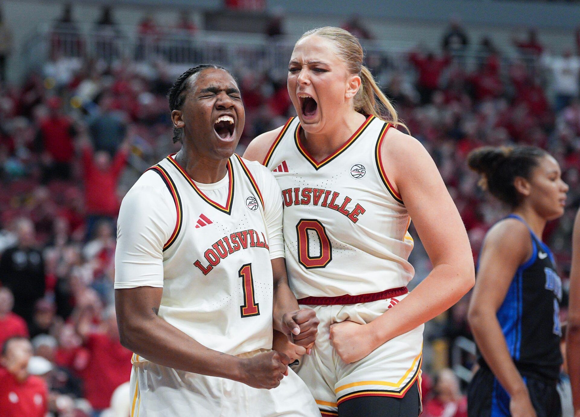 Louisville Cardinals guard Reyna Scott (1) celebrates after scoring two plus drawing the Duke foul with Louisville Cardinals forward Laura Ziegler (0) in the second half of women's college basketball at the KFC Yum! Center Thursday night Feb. 5, 2026.