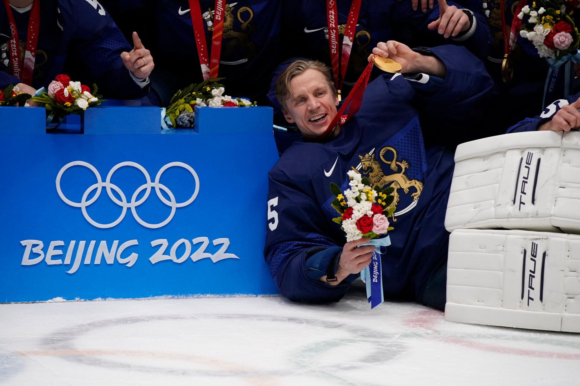 Team Finland goalkeeper Jussi Olkinuora (45) poses with teammates for a team picture after the medals ceremony during the Beijing 2022 Olympic Winter Games at National Indoor Stadium.