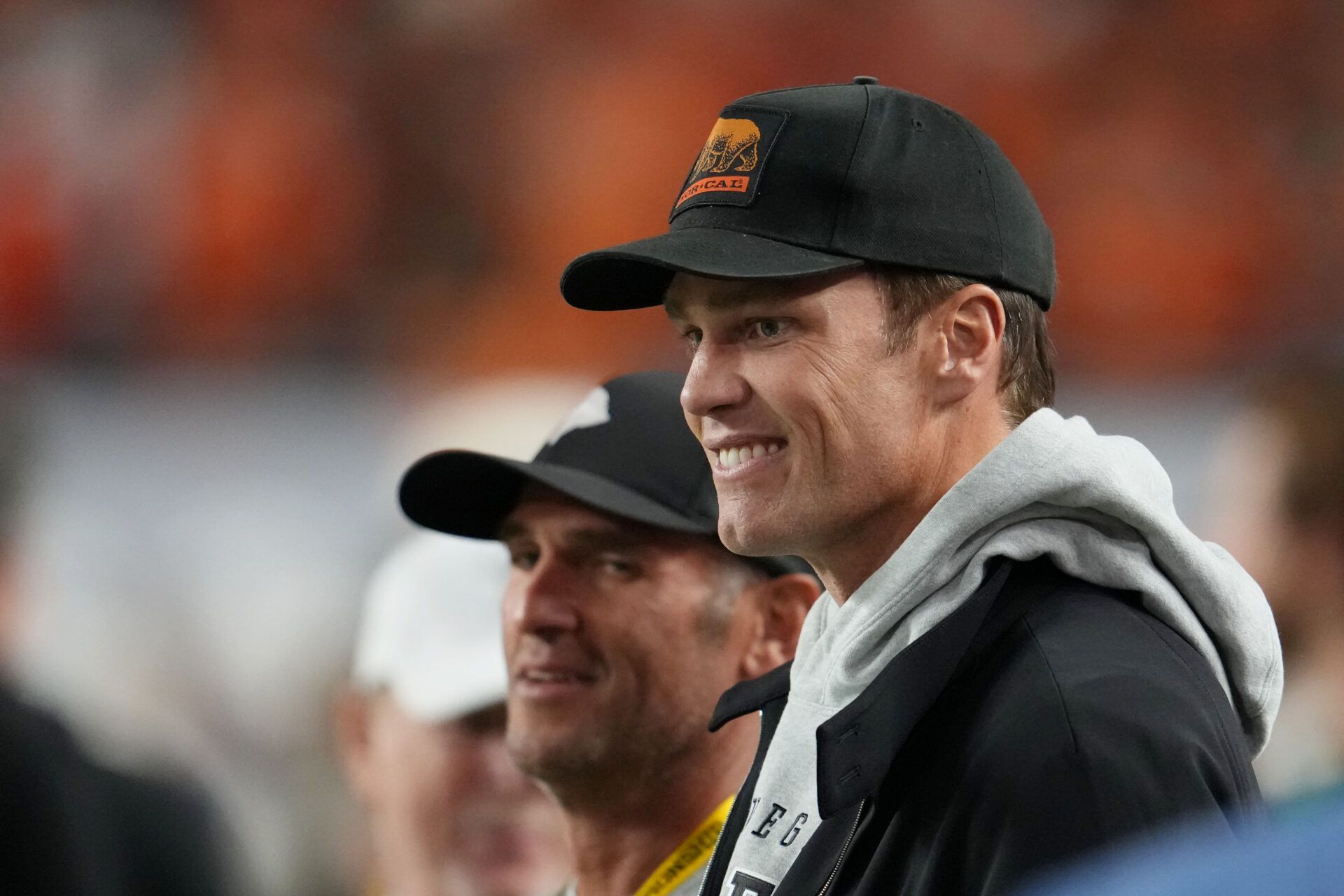 Tom Brady looks on from the sideline before the CFP National Championship college football game between the Indiana Hoosiers and the Miami Hurricanes at Hard Rock Stadium.