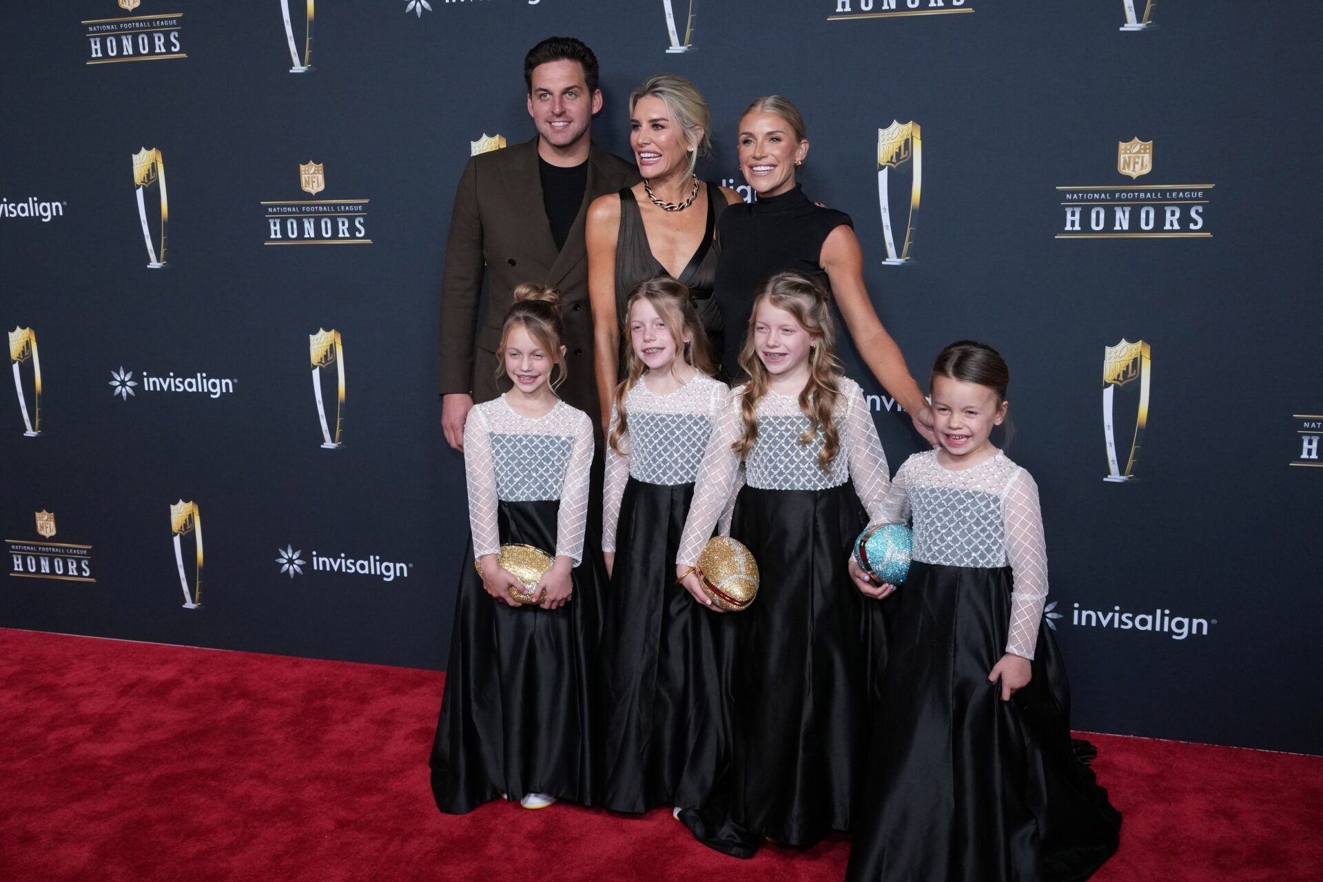Steve Cundari and Charissa Thompson and Kelly Stafford, the wife of Los Angeles Rams quarterback Matthew Stafford, poses with daughters Sawyer Stafford, Chandler Stafford, Hunter Stafford and Tyler Stafford on the NFL Honors Red Carpet before Super Bowl LX at Palace of Fine Arts.