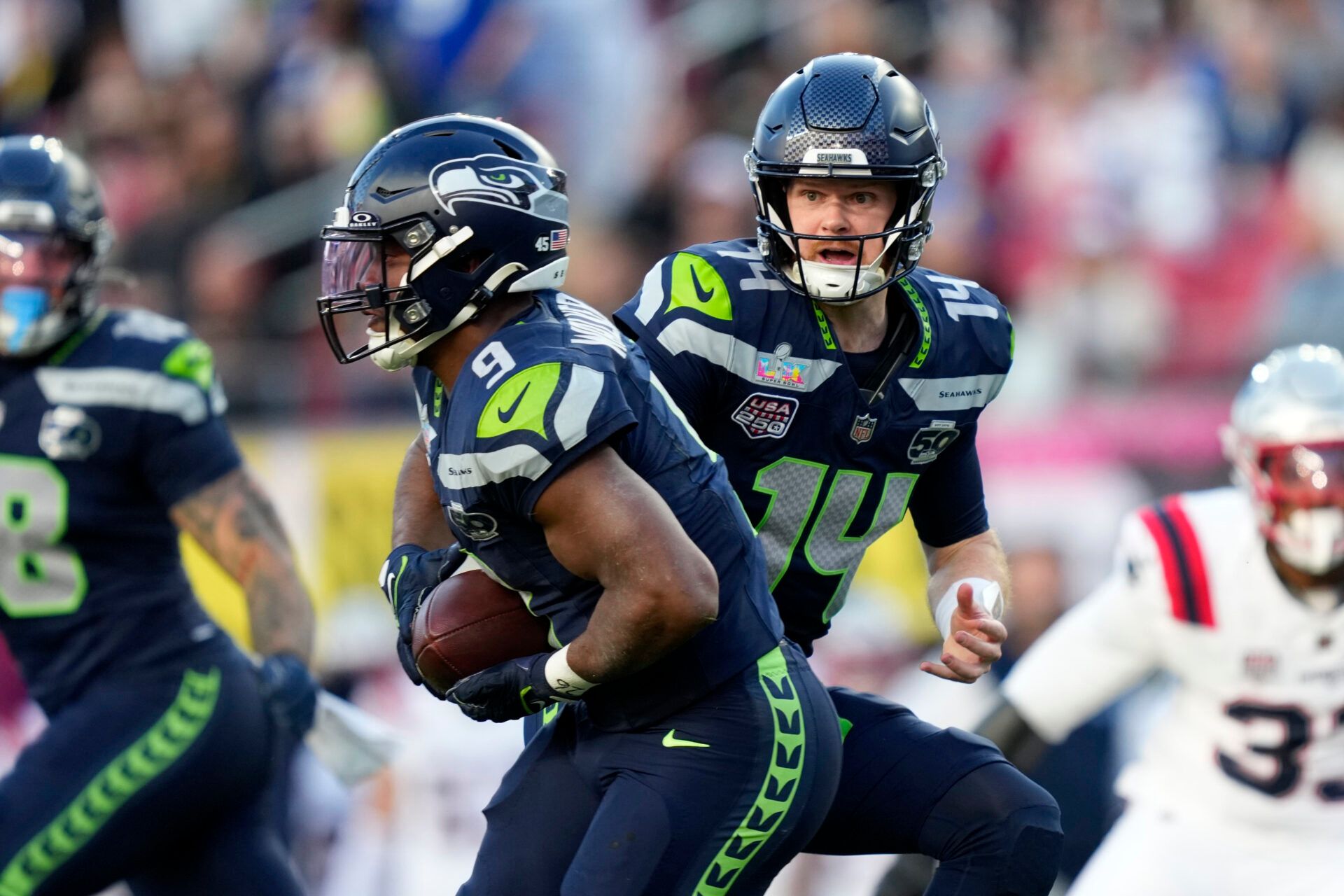 Seattle Seahawks quarterback Sam Darnold (14) hands off to running back Kenneth Walker III (9) during the first quarter against the New England Patriots in Super Bowl LX at Levi's Stadium.