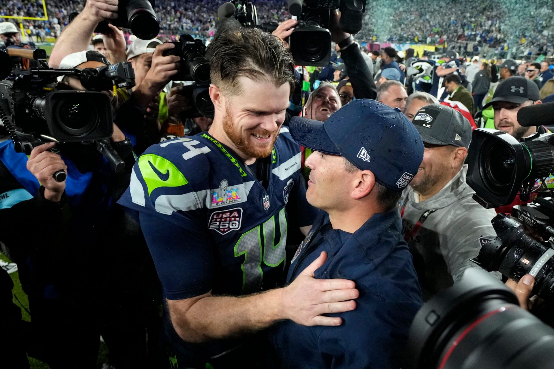 Seattle Seahawks head coach Mike MacDonald celebrates with quarterback Sam Darnold (14) after defeating the New England Patriots in Super Bowl LX at Levi's Stadium.