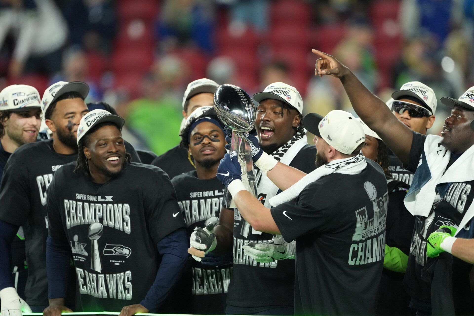 Seattle Seahawks players celebrate with the Vince Lombardi Trophy after defeating the New England Patriots in Super Bowl LX at Levi's Stadium.