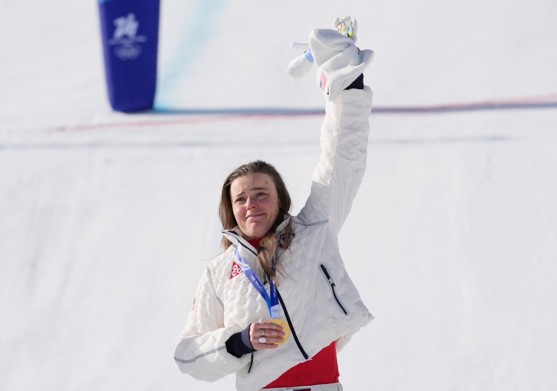 Breezy Johnson of the United States celebrates on the podium with her gold medal in the women's downhill alpine skiing race during the Milano Cortina 2026 Olympic Winter Games at Tofane Alpine Skiing Centre.