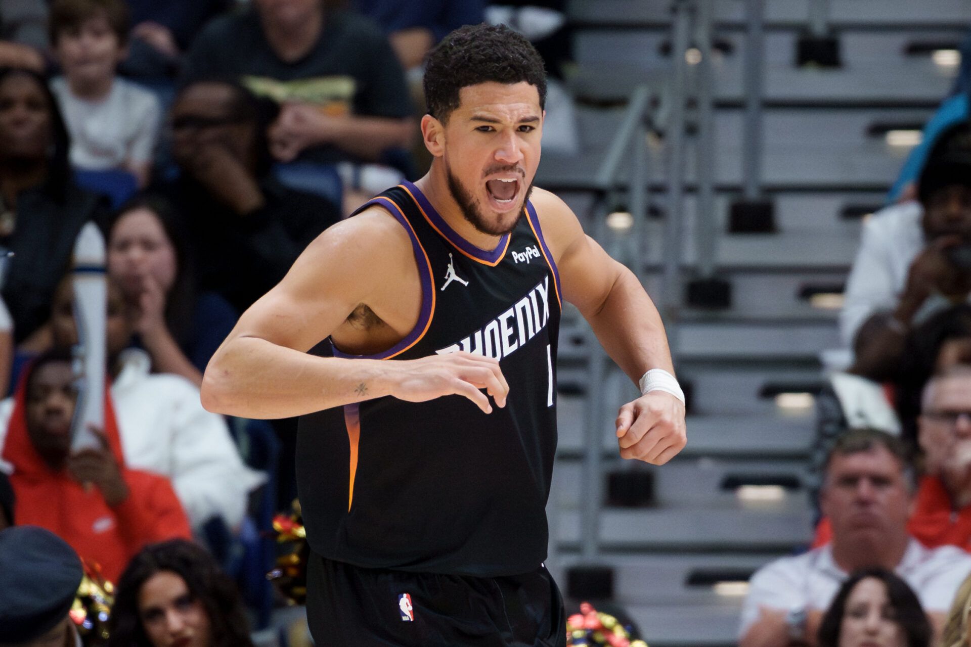 Phoenix Suns guard Devin Booker (1) reacts after a score but was later called for technical foul against the New Orleans Pelicans during the fourth quarter at Smoothie King Center.