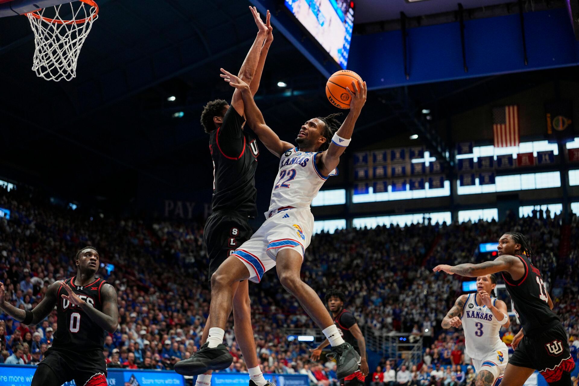 Kansas Jayhawks guard Darryn Peterson (22) shoots against Utah Utes forward Josh Hayes (7) during the second half at Allen Fieldhouse.