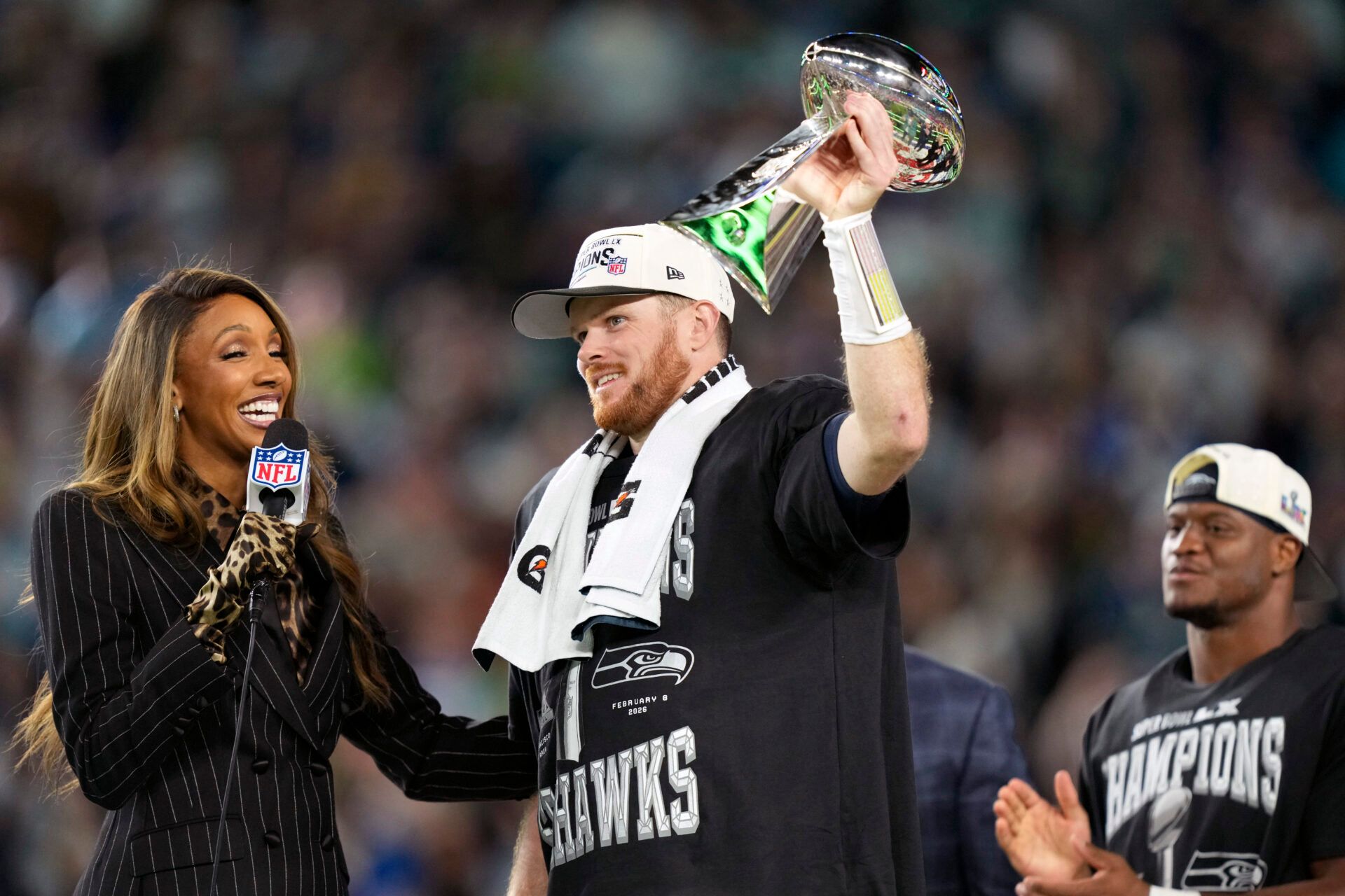 Seattle Seahawks quarterback Sam Darnold (14) celebrates with the Vince Lombardi trophy after defeating the New England Patriots in Super Bowl LX at Levi's Stadium.