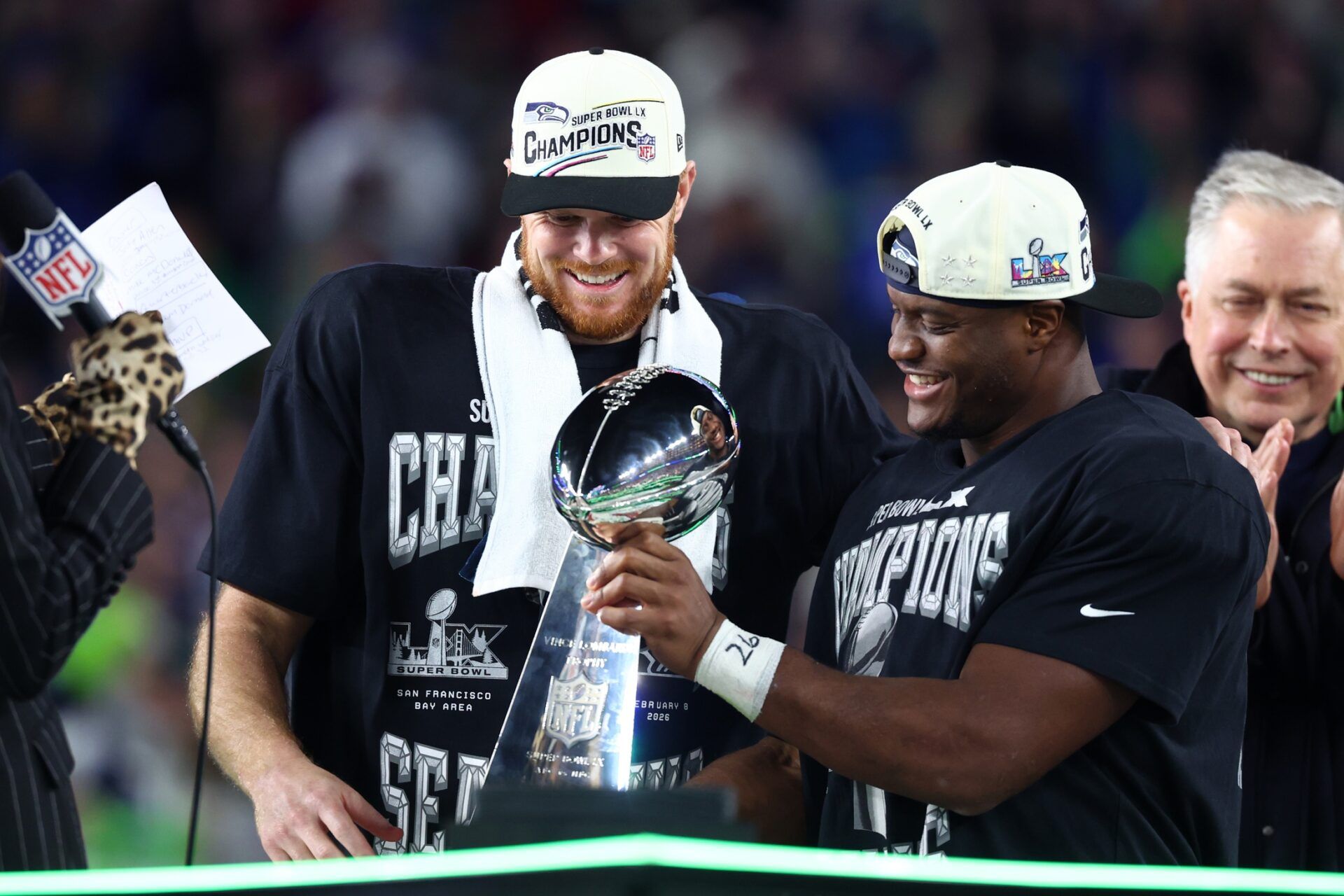Seattle Seahawks quarterback Sam Darnold (14) and running back Kenneth Walker III (9) celebrate with the Vince Lombardi trophy after defeating the New England Patriots in Super Bowl LX at Levi's Stadium.