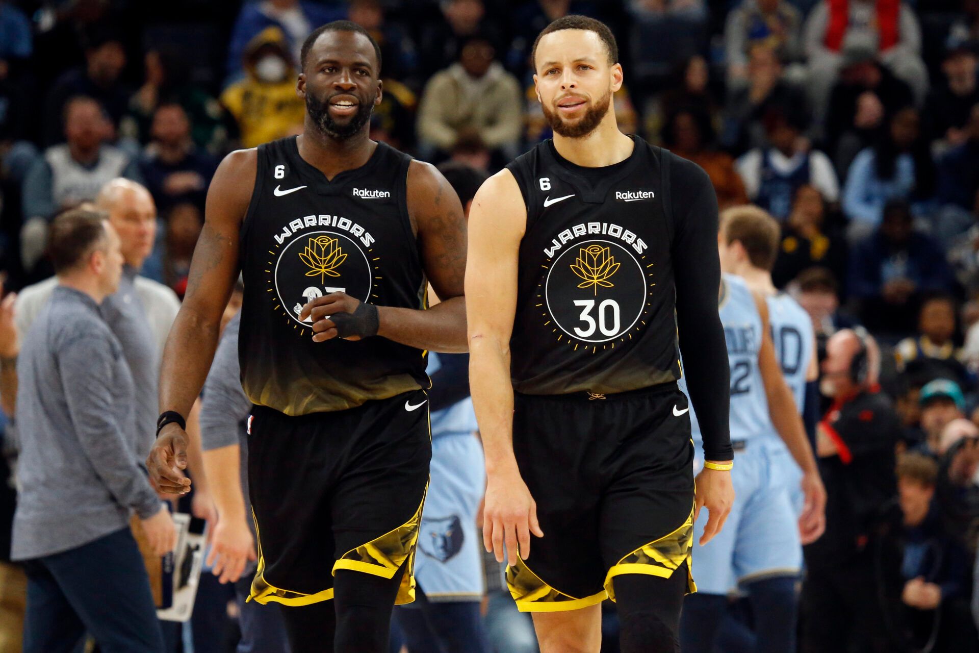 Golden State Warriors forward Draymond Green (23) and guard Stephen Curry (30) walk toward the bench during a timeout during the second half against the Memphis Grizzlies at FedExForum.