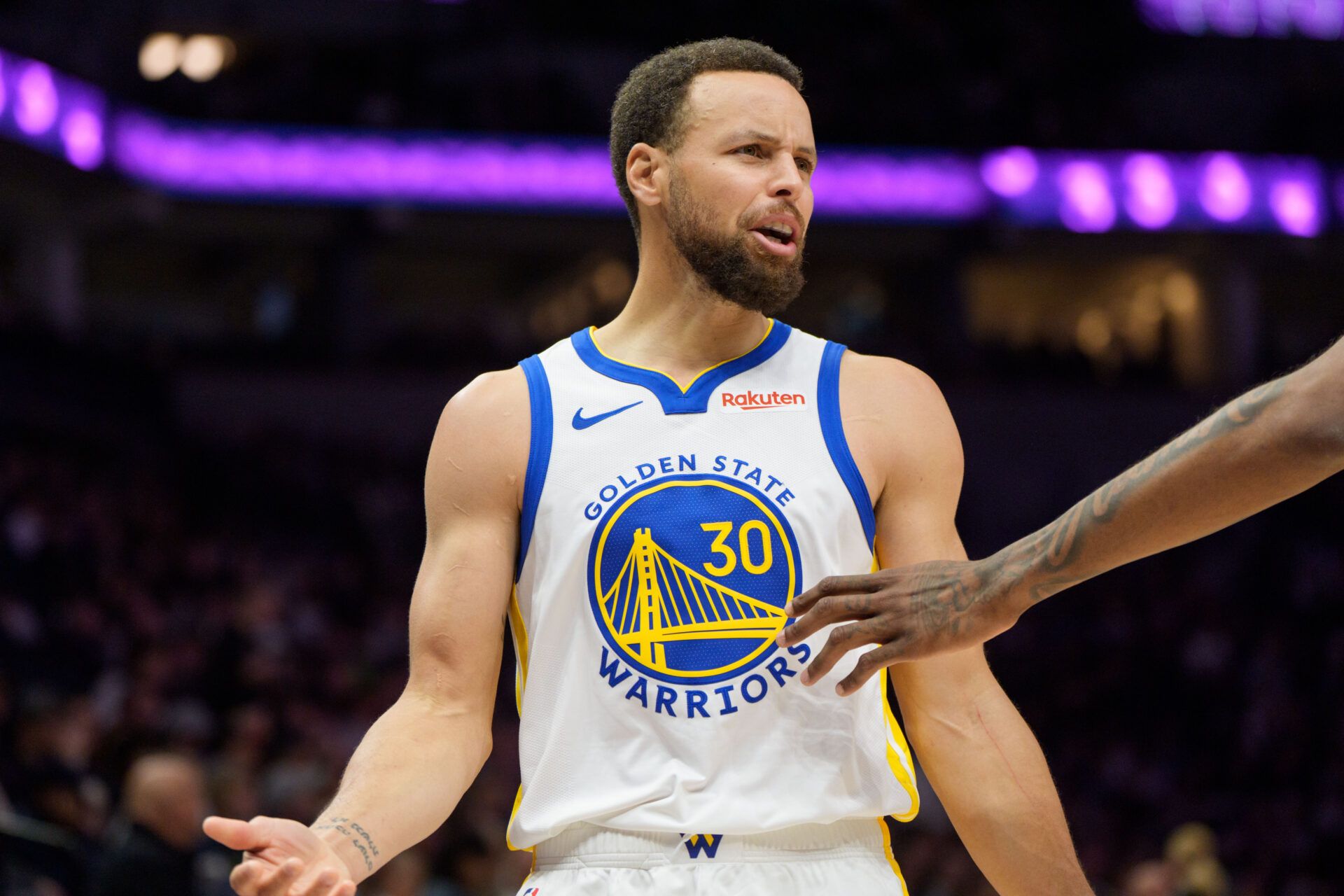 Golden State Warriors guard Stephen Curry (30) talks with a Minnesota Timberwolves player in the third quarter at Target Center.