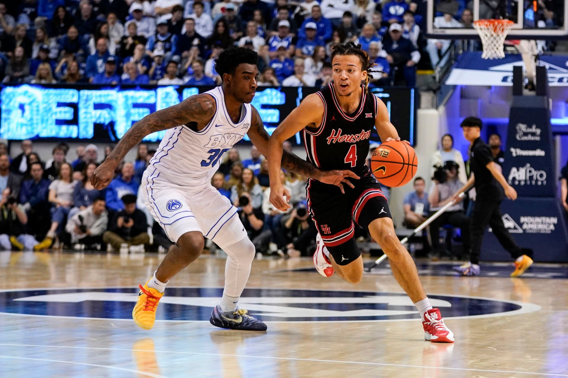 Houston Cougars guard Kingston Flemings (4) controls the ball while being defended by BYU Cougars forward Kennard Davis Jr. (30) during the second half  at Marriott Center.