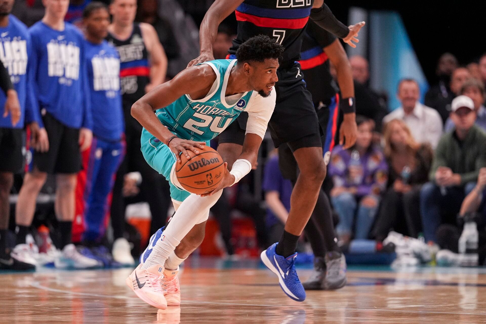 Charlotte Hornets forward Brandon Miller (24) grabs a pass defended by Detroit Pistons forward Paul Reed (7) during the second half at Spectrum Center.