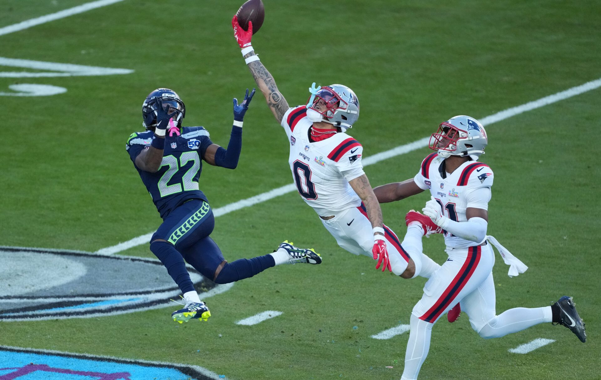 New England Patriots cornerback Christian Gonzalez (0) breaks up a pass intended for Seattle Seahawks wide receiver Rashid Shaheed (22) in the first half in Super Bowl LX at Levi's Stadium.