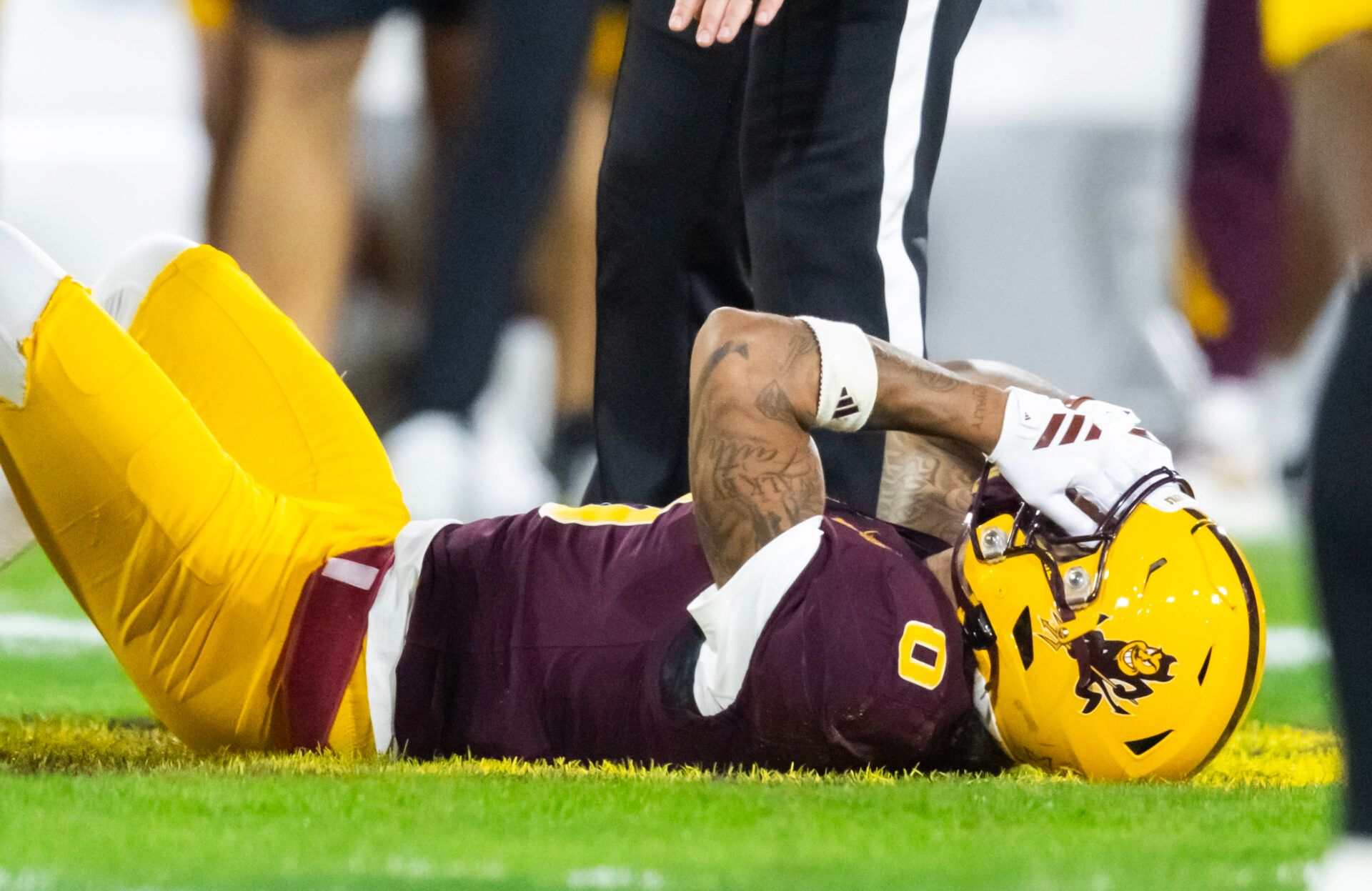Arizona State Sun Devils wide receiver Jordyn Tyson (0) reacts after suffering an injury against the Arizona Wildcats in the first half during the 99th Territorial Cup at Mountain America Stadium.