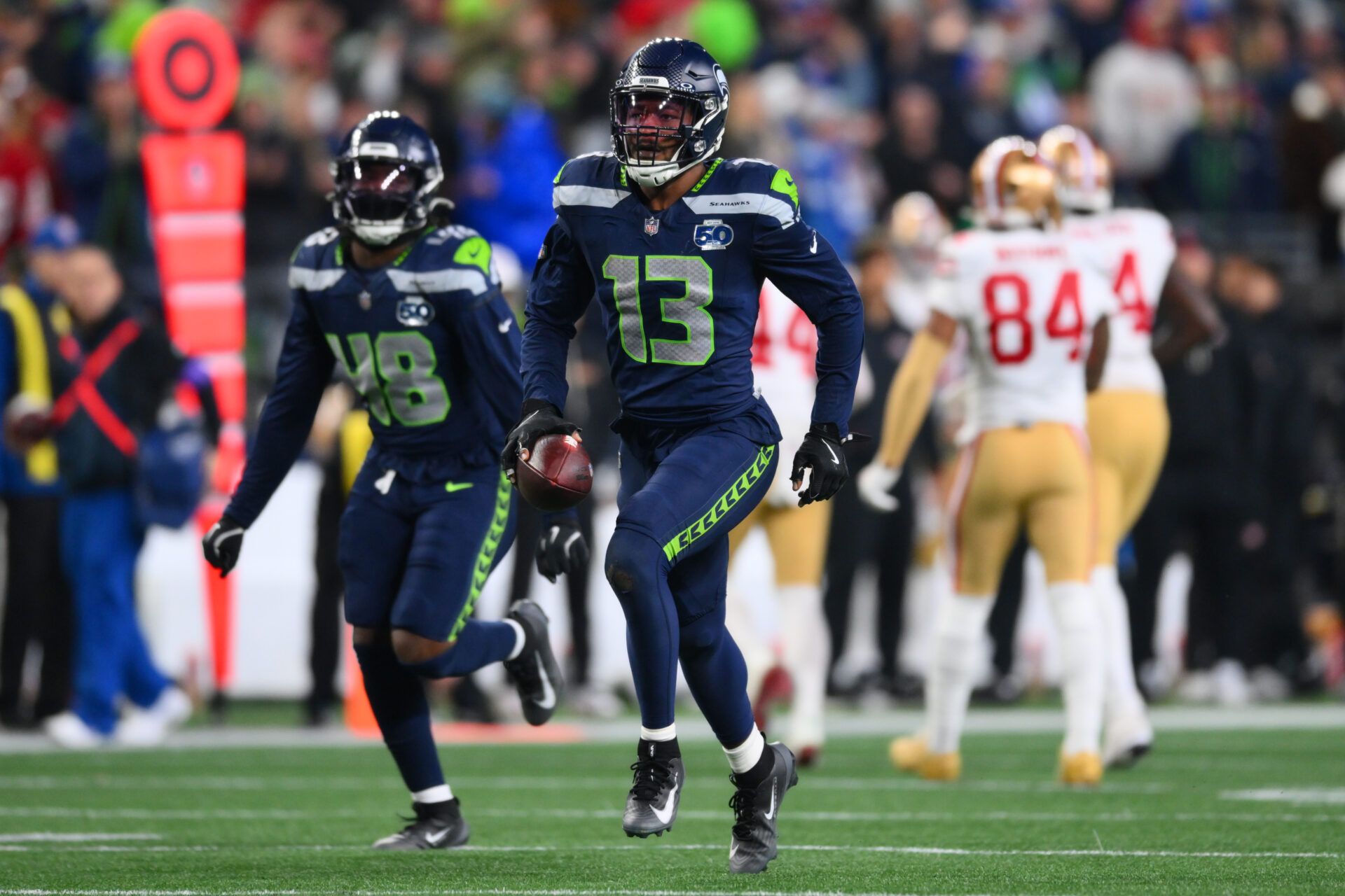 Seattle Seahawks linebacker Ernest Jones IV (13) reacts after an interception against the San Francisco 49ers during the second half in an NFC Divisional Round game at Lumen Field.