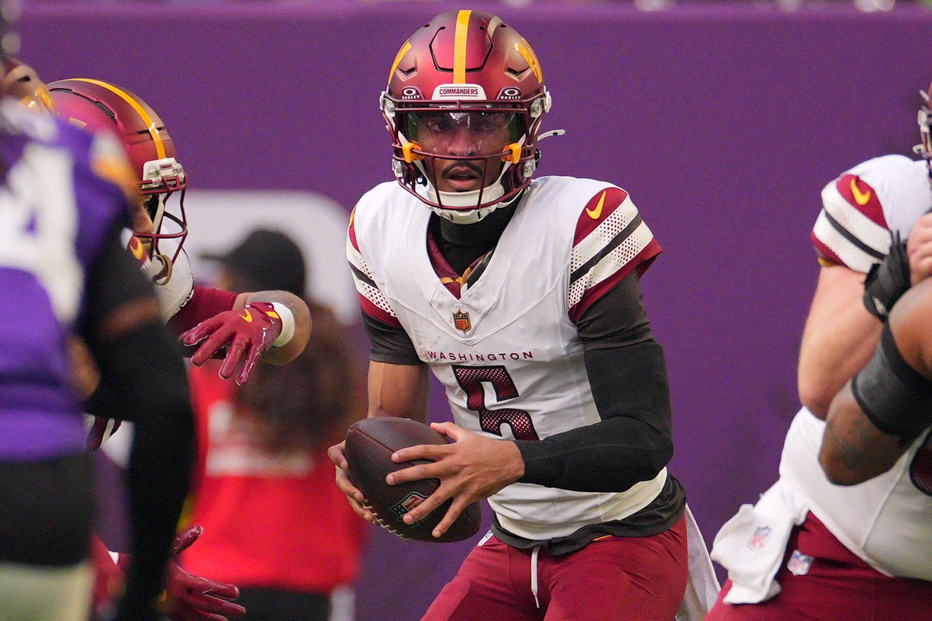 Washington Commanders quarterback Jayden Daniels (5) drops back to pass against the Minnesota Vikings during the first half at U.S. Bank Stadium.