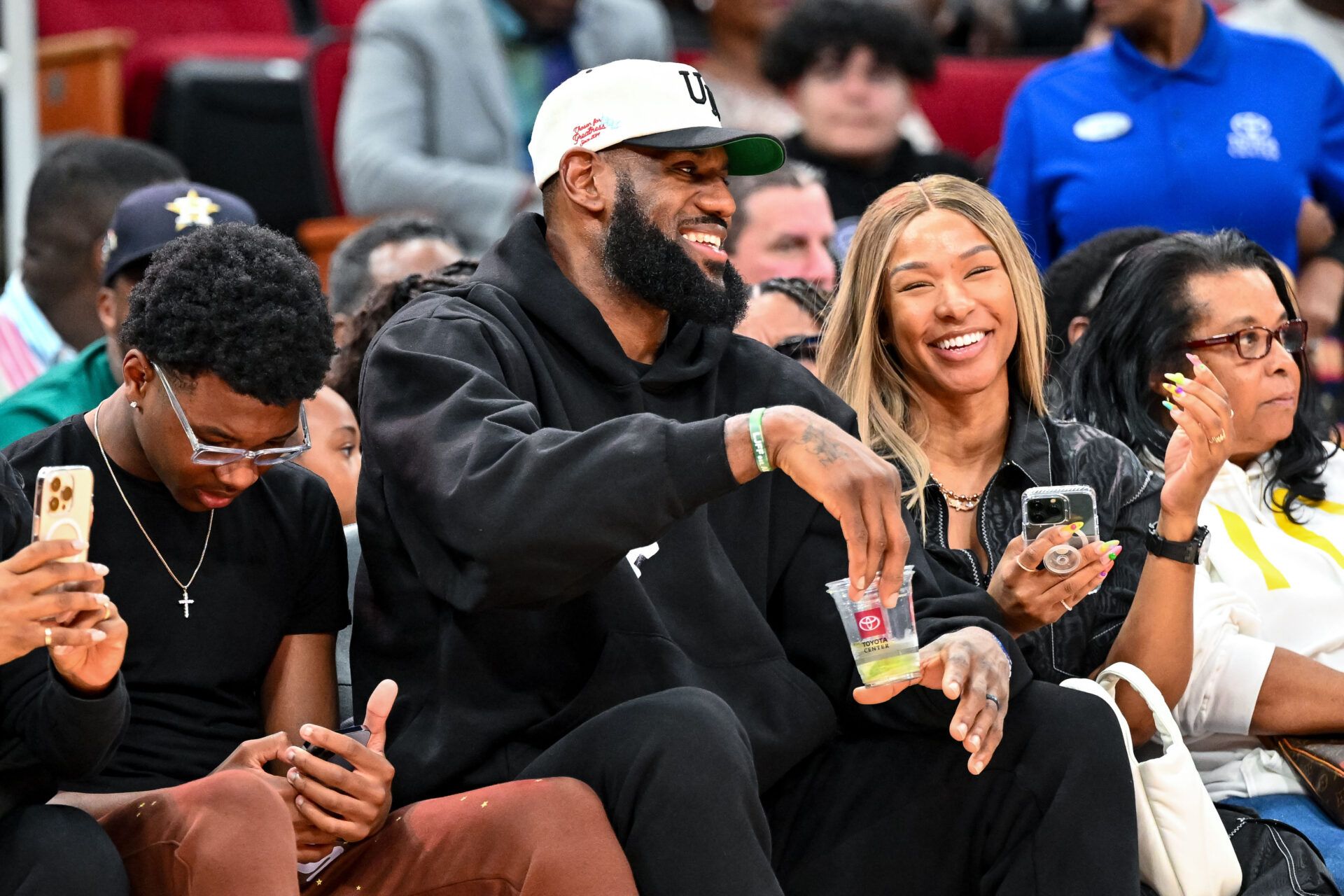 Los Angeles Laker LeBron James and his wife Savannah James sit court side at the McDonald's All American game during the first half at Toyota Center.