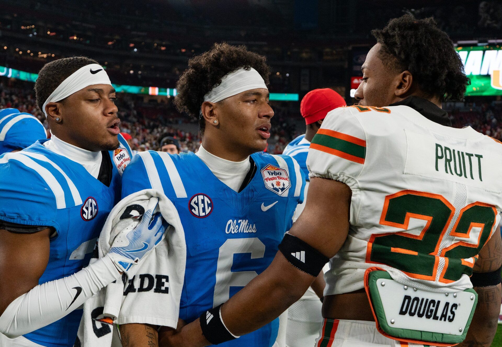 Ole Miss quarterback Trinidad Chambliss (6) talks to Miami Hurricanes linebacker Cam Pruitt (22) after losing the CFP Fiesta Bowl against Miami at the State Farm Stadium, in Glendale, Ariz., on Thursday, Jan. 8, 2026.