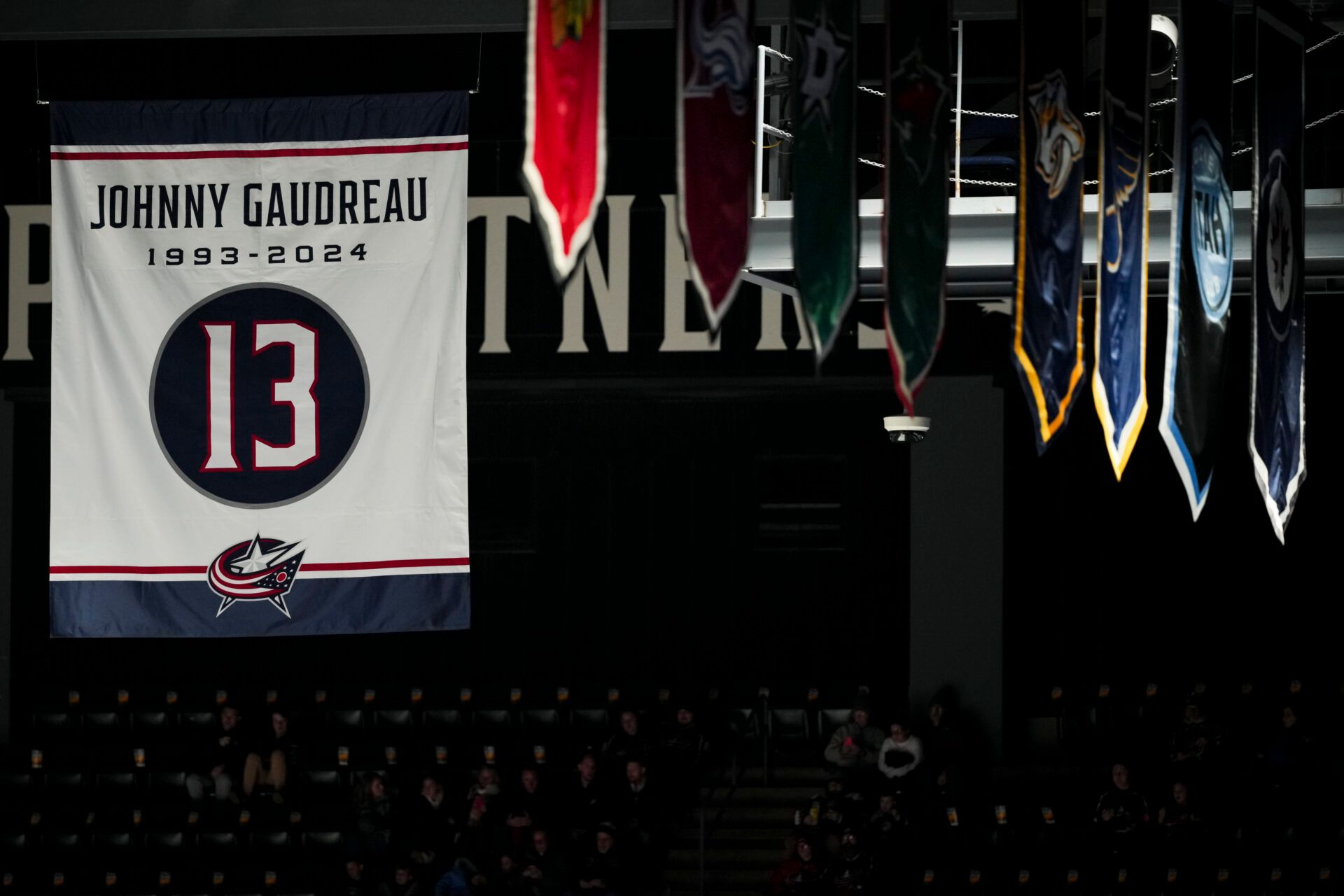 A banner honoring the late Johnny Gaudreau is seen in the rafters before the game between the Calgary Flames and the Columbus Blue Jackets at Nationwide Arena.