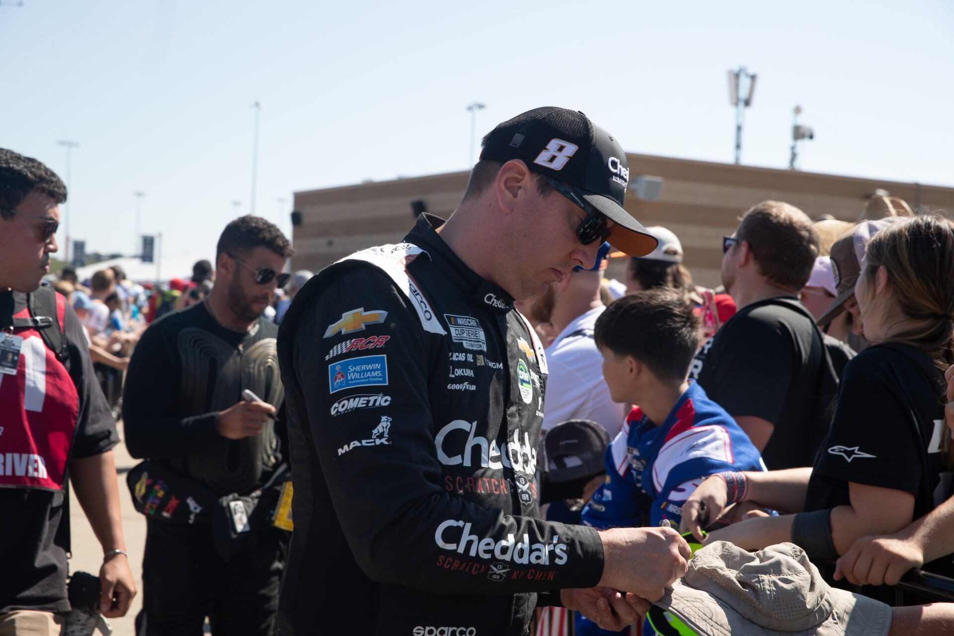 Kyle Busch signs autographs before the NASCAR Cup Series Playoff Race at Kansas Speedway.