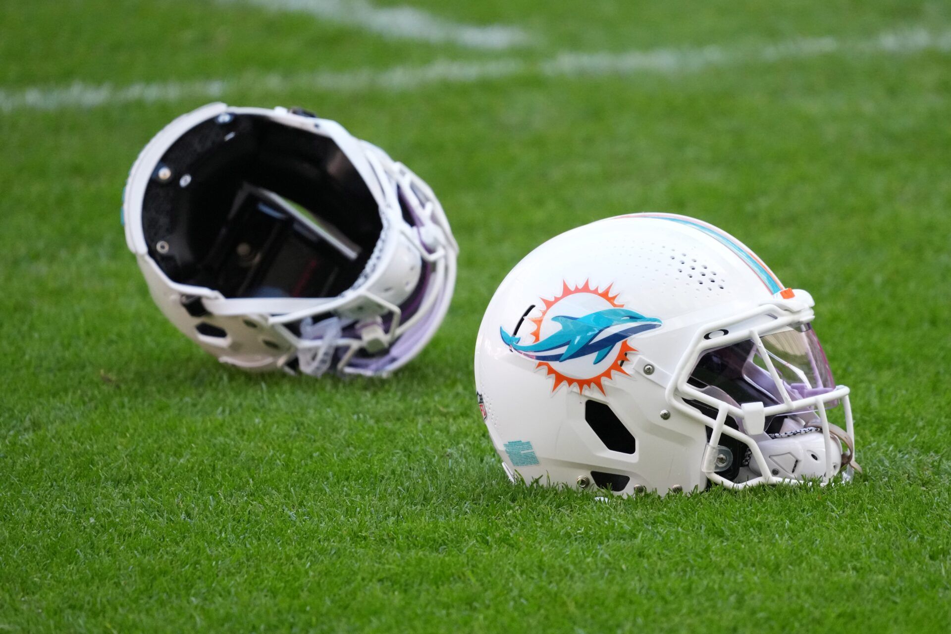 Miami Dolphins helmets on the field during practice at Estadio Riyadh Air Metropolitano.