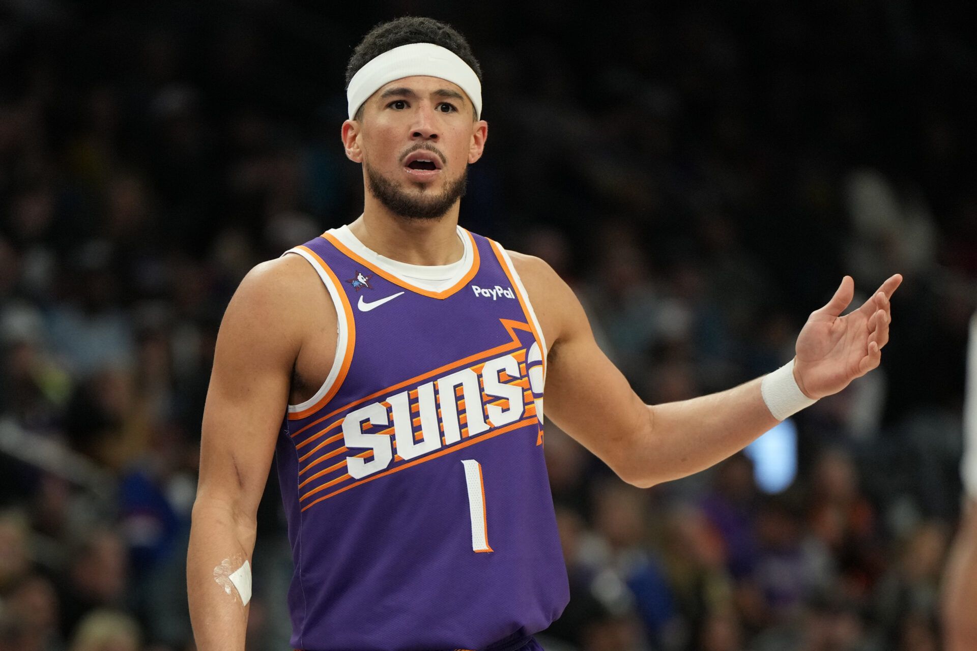 Phoenix Suns guard Devin Booker (1) reacts after a foul call against the Philadelphia 76ers during the second half of an NBA game at Mortgage Matchup Center.