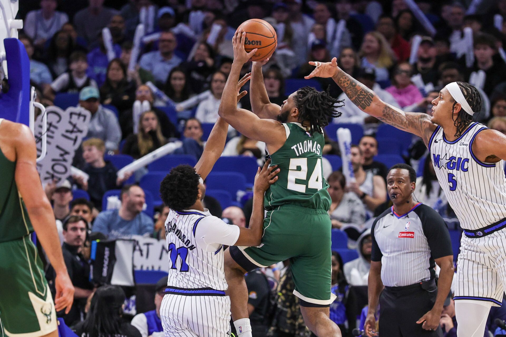 Milwaukee Bucks guard Cam Thomas (24) is fouled by Orlando Magic guard Jase Richardson (11) during the second half at Kia Center.