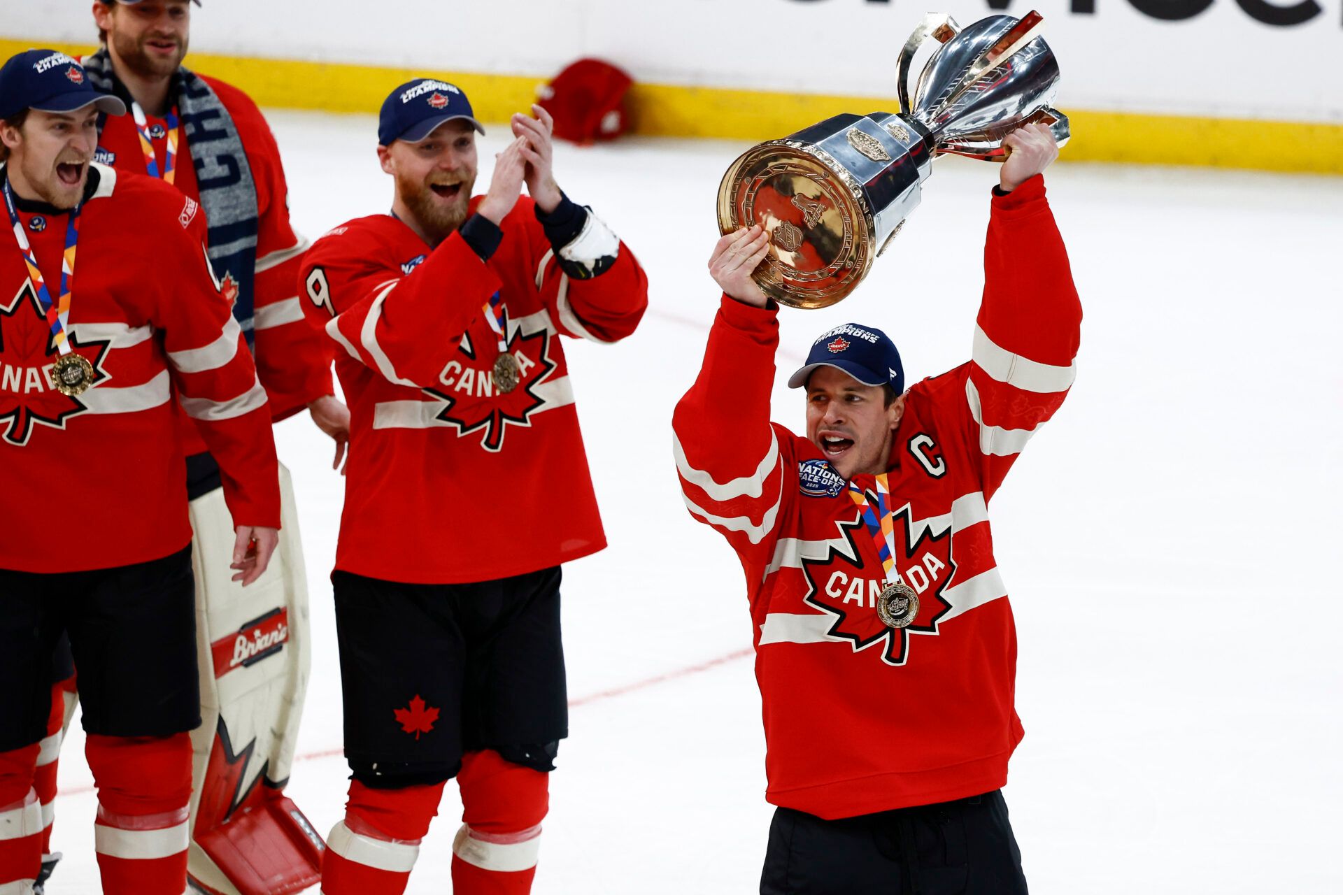 Team Canada forward Sydney Crosby (87) lifts the trophy at TD Garden.