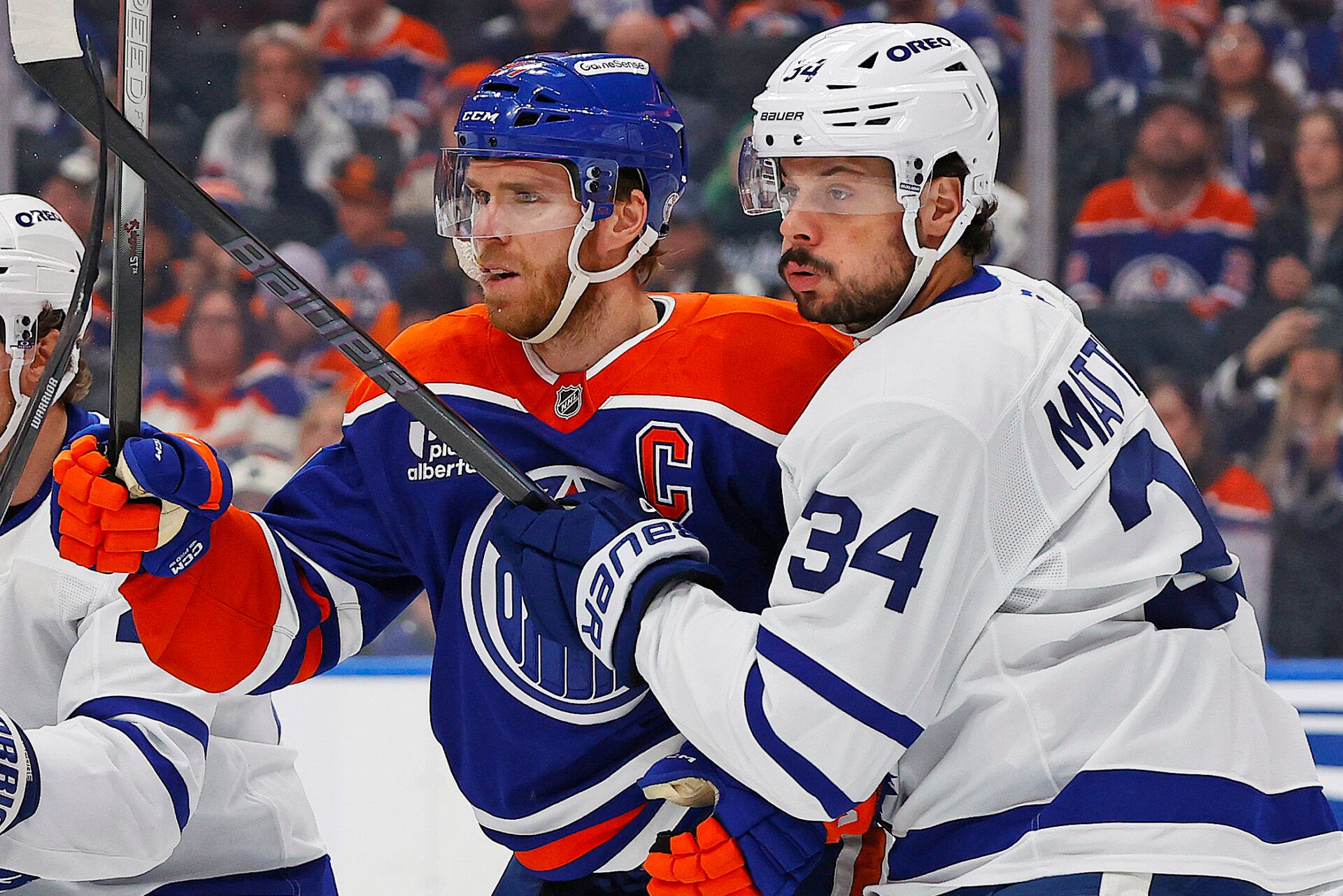 Edmonton Oilers forward Connor McDavid (97) and Toronto Maple Leafs forward Auston Matthews (34) battle for position during the first period at Rogers Place.