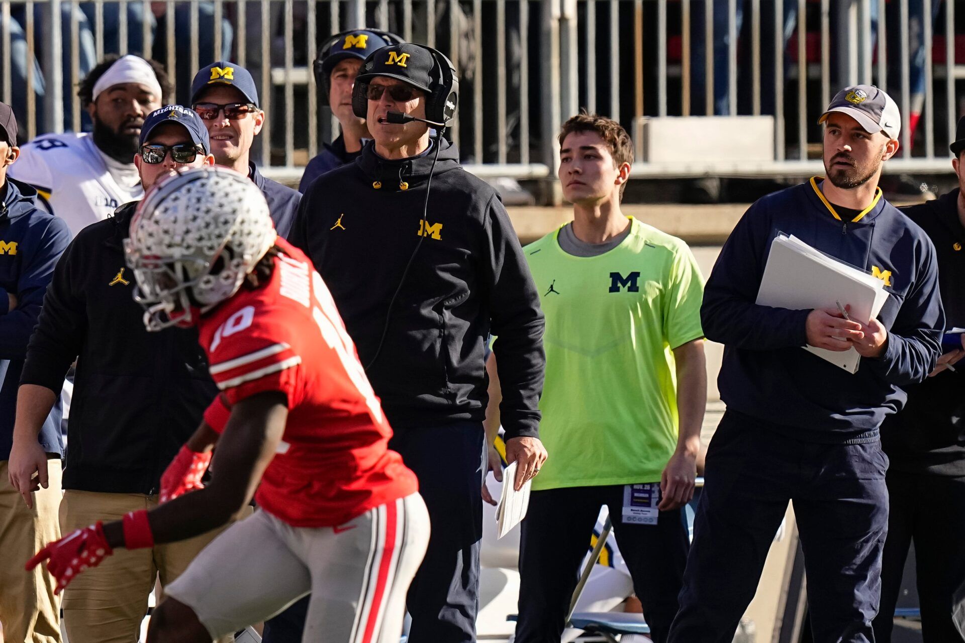 Michigan Wolverines head coach Jim Harbaugh watches from the sideline beside off-field analyst Connor Stalions, right, during the NCAA football game against the Ohio State Buckeyes at Ohio Stadium.