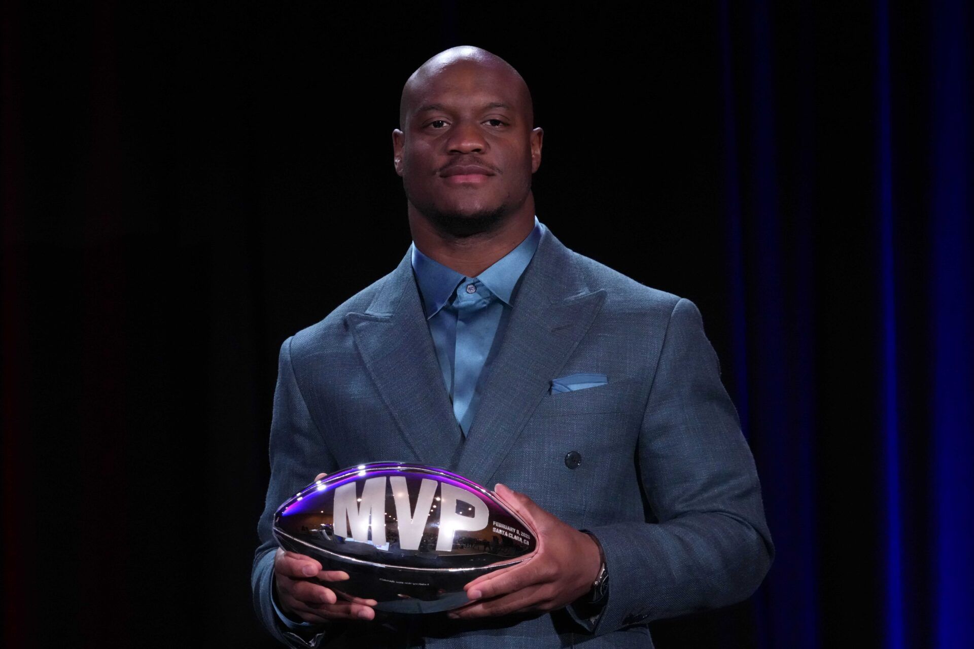 Seattle Seahawks running back Kenneth Walker III poses with the MVP trophy during the Super Bowl LX winning head coach and most valuable player press conference at Moscone Center.