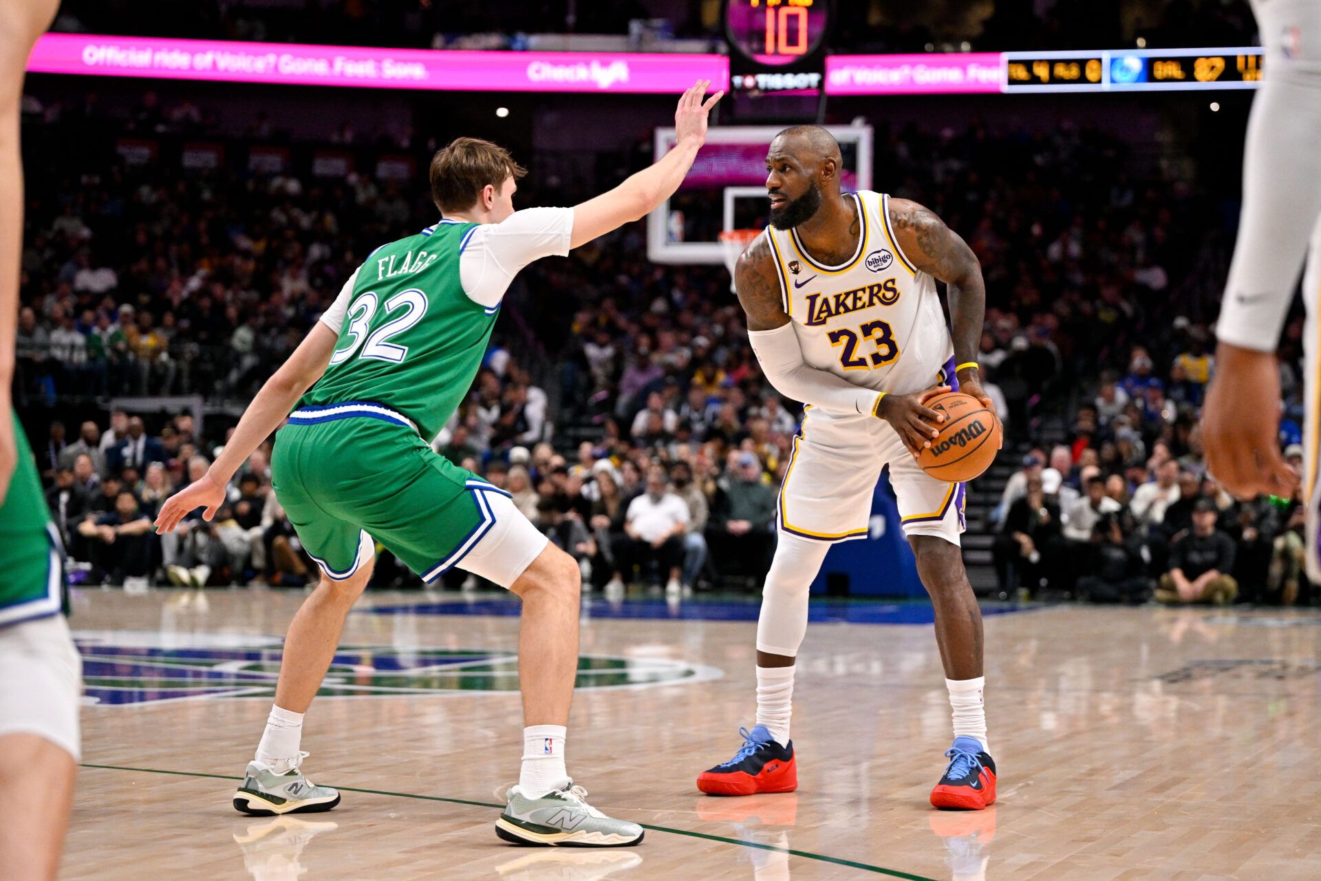 Los Angeles Lakers forward LeBron James (23) looks to move the ball past Dallas Mavericks forward Cooper Flagg (32) during the game at the American Airlines Center.