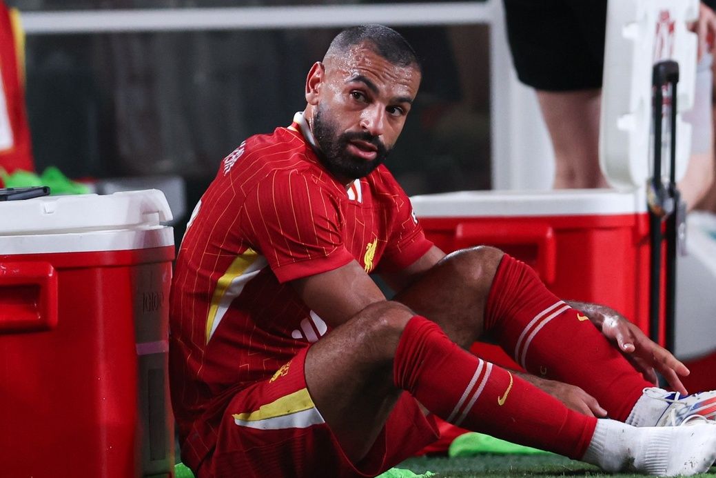 Liverpool forward Mohamed Salah (11) removes his cleats after being subbed out during the second half against Arsenal at Lincoln Financial Field.