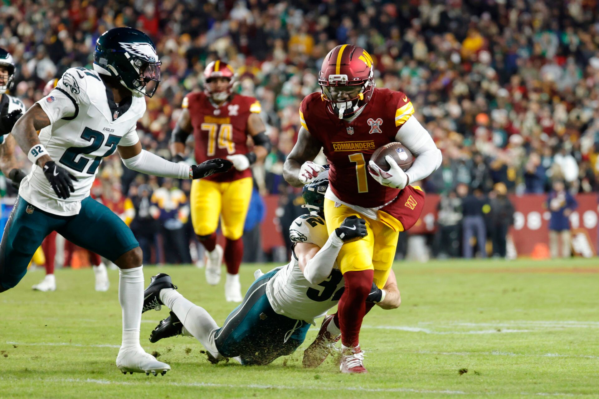 Washington Commanders wide receiver Deebo Samuel (1) runs against Philadelphia Eagles cornerback Quinyon Mitchell (27) and safety Reed Blankenship (32) during the first half at Northwest Stadium.