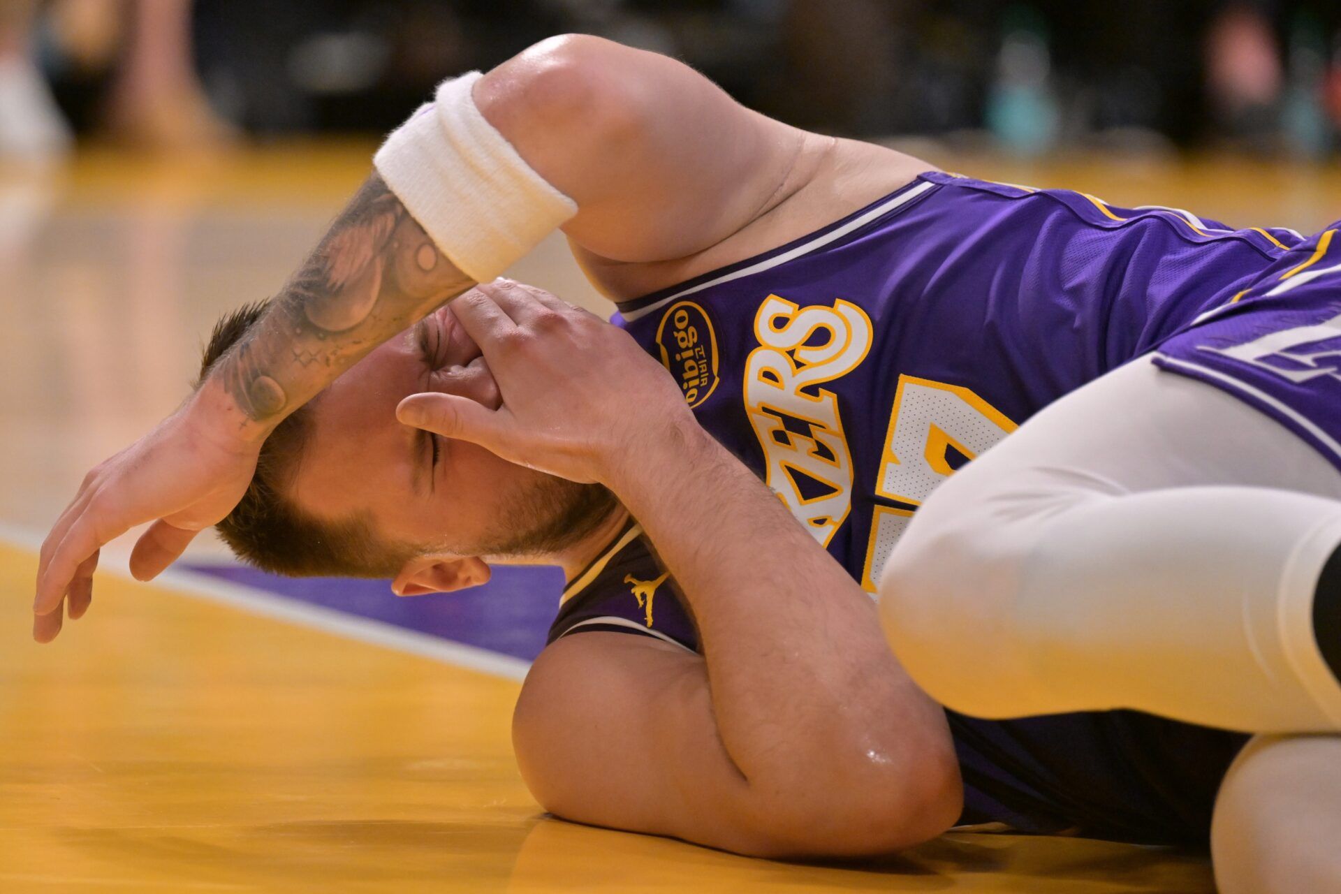 Los Angeles Lakers guard Luka Doncic (77) reacts after he was hit in the face defending a shot in the first half against the Philadelphia 76ers at Crypto.com Arena.