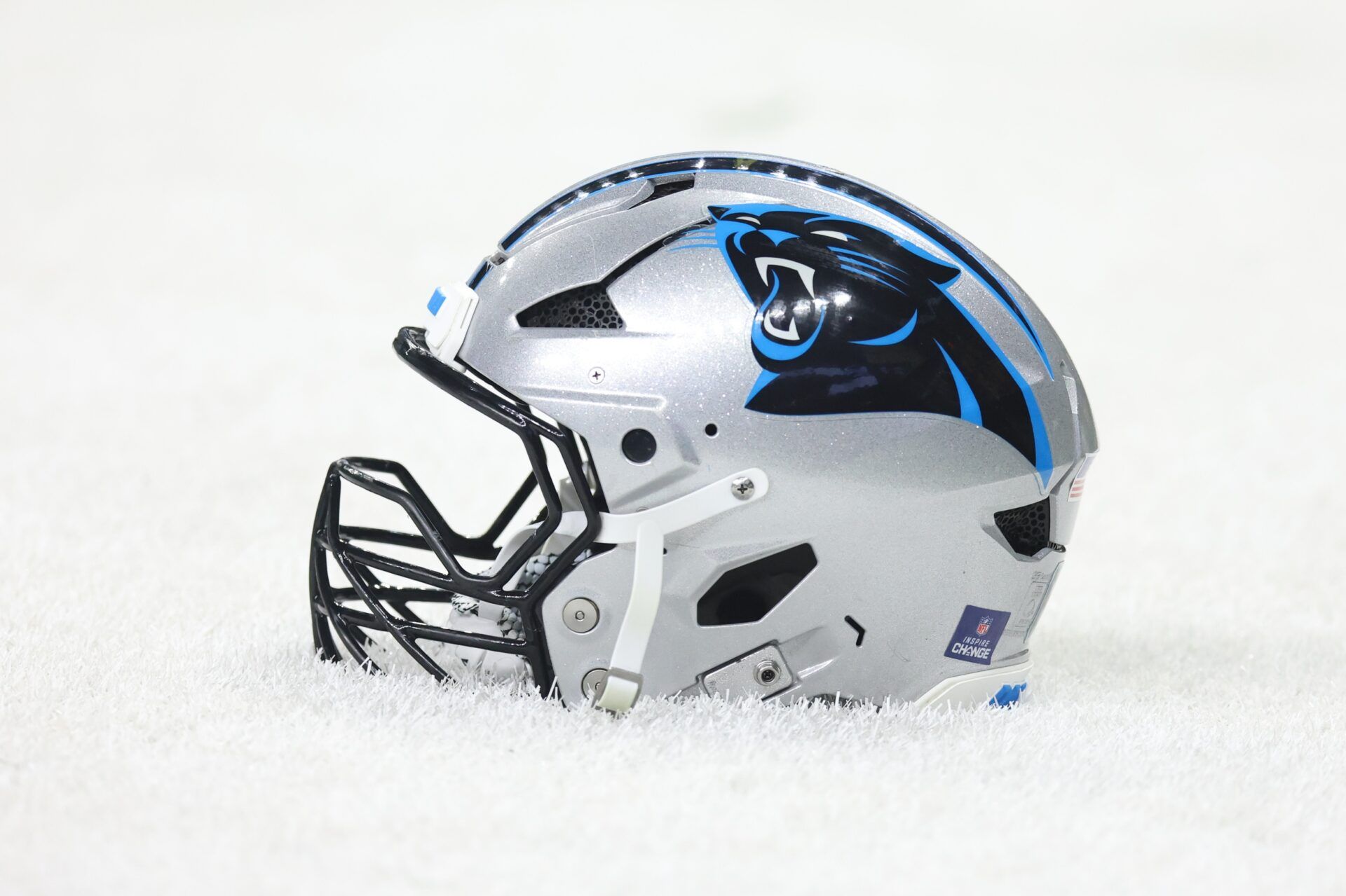 Detailed shot of a Carolina Panthers helmet on the grass before the game against the New Orleans Saints at Caesars Superdome.
