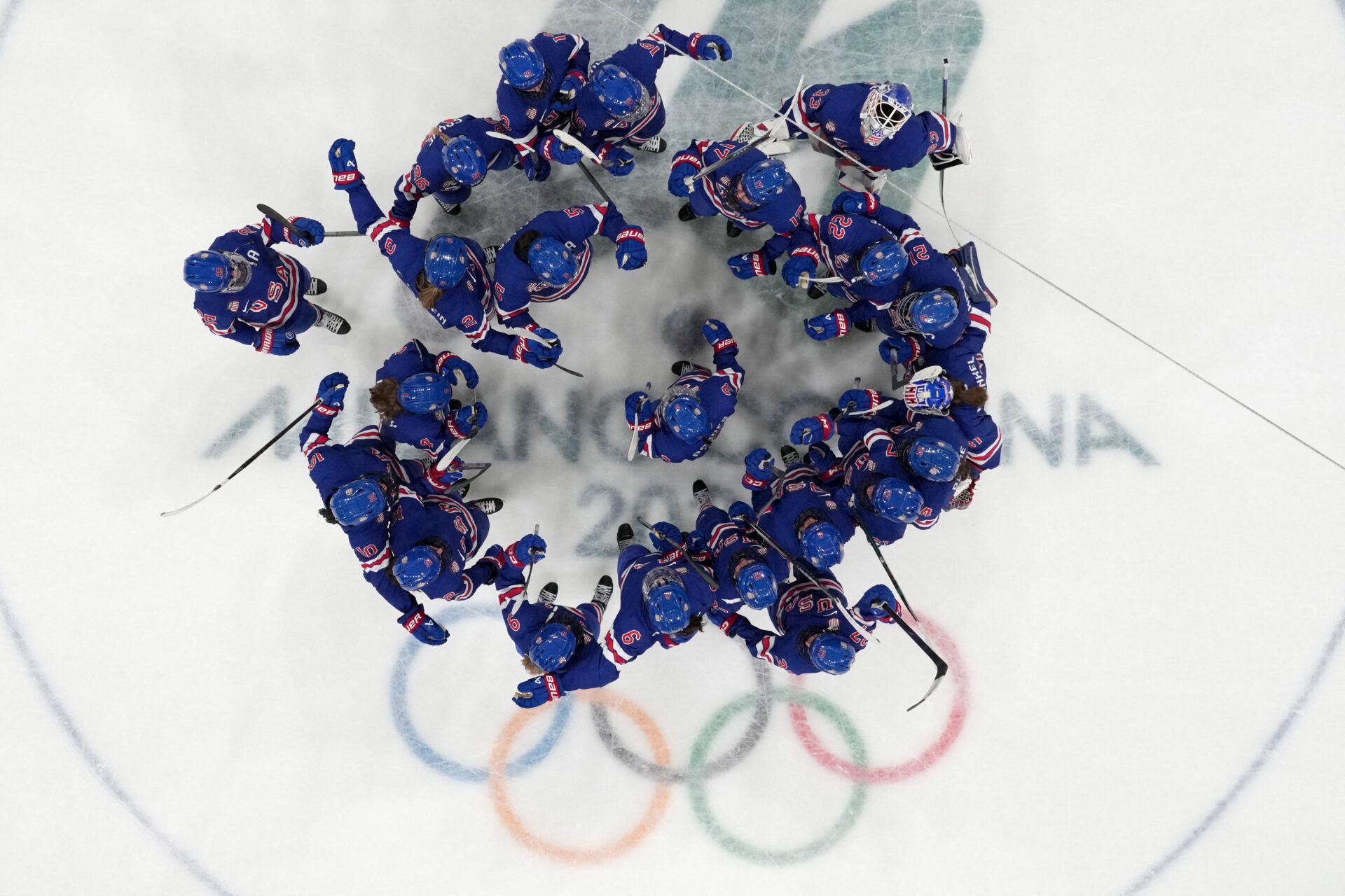 United States players celebrate at the end of the match at Milano Rho Ice Hockey Arena.