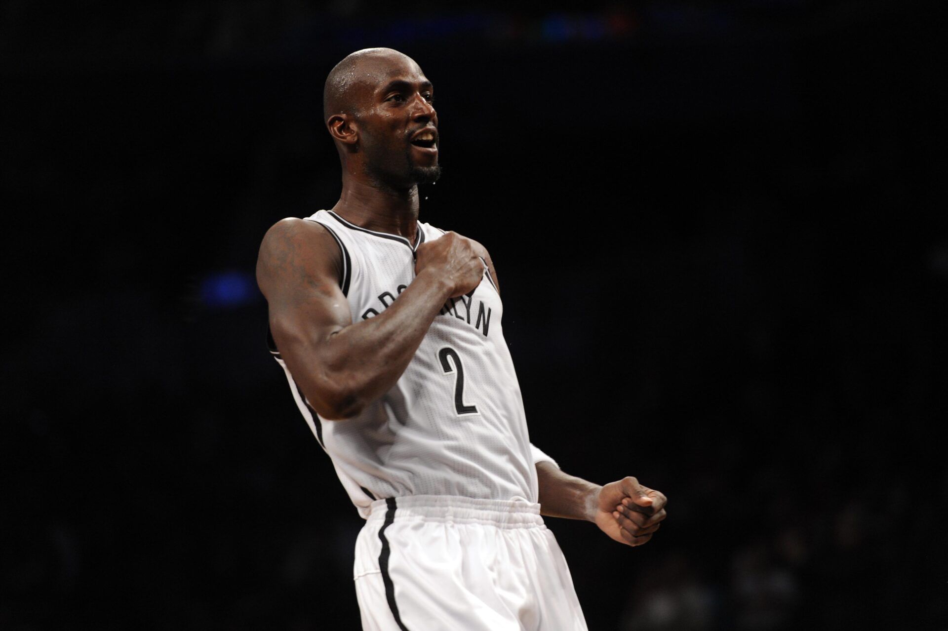 Brooklyn Nets power forward Kevin Garnett (2) pumps up fans during the first half of the preseason game against the Detroit Pistons at Barclays Center.